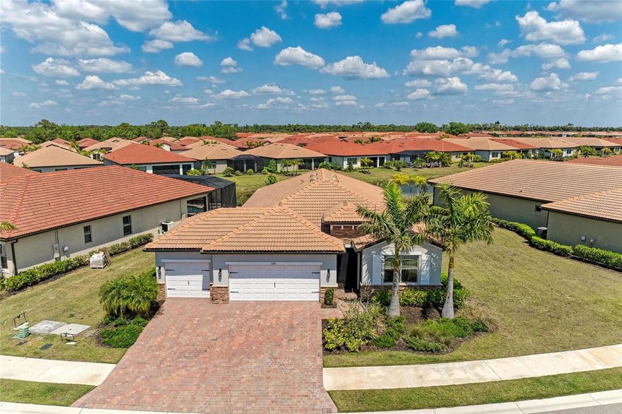 This is your opportunity for an almost new, immaculate 4BR (or 3BR+Den) lakefront home with a 3-car garage and an oversized pie-shaped lot that is nearly a quarter of an acre. This homesite offers plenty of room for a pool and a fenced yard for your 4-legged companions. This beautifully finished home offers wood look plank tile floors throughout main living area, high ceilings, 8-foot doors, extensive crown molding, and large baseboards.  The open kitchen includes modern white cabinets with soft close, crown molding, light valances, and beautiful Quartz countertops. The Kitchen Aid upgraded stainless steel appliances are ready for the gourmet chef in you.  The spacious great room overlooks the wide lanai and the lake beyond.  The large primary suite is situated at the back of the home, offering 2 walk-in closets, and a bath that includes dual sinks and a large walk-in shower with frameless enclosure, upgraded tile, and a beautiful listello. The guest bedrooms, located at the front of the home, offer great privacy for your family or friends.  Toscana Isles is a gated, resort-style community known for its quality amenities and active lifestyle, providing a secure and enjoyable environment. Imagine kayaking, canoeing, or fishing on over 200 acres of stunning interconnected lakes! The grand 8,000-square-foot clubhouse serves as a vibrant social hub, featuring a fitness center, ballroom, and billiards room with a big-screen TV-perfect for unforgettable gatherings and exciting activities. And let's not overlook the unbeatable location! Just a short 10-minute drive will transport you to the stunning Suncoast beaches, the scenic Legacy Trail, and a fantastic array of shopping, dining, and cultural attractions in Venice and Sarasota. Plus, with the new Sarasota Memorial Hospital campus nearby, you'll have everything you need right at your fingertips. Don't let this remarkable opportunity pass you by! Elevate your lifestyle in a community and home that truly embodies luxury and enjoyment. Contact us today for your private showing, you'll be thrilled you did!