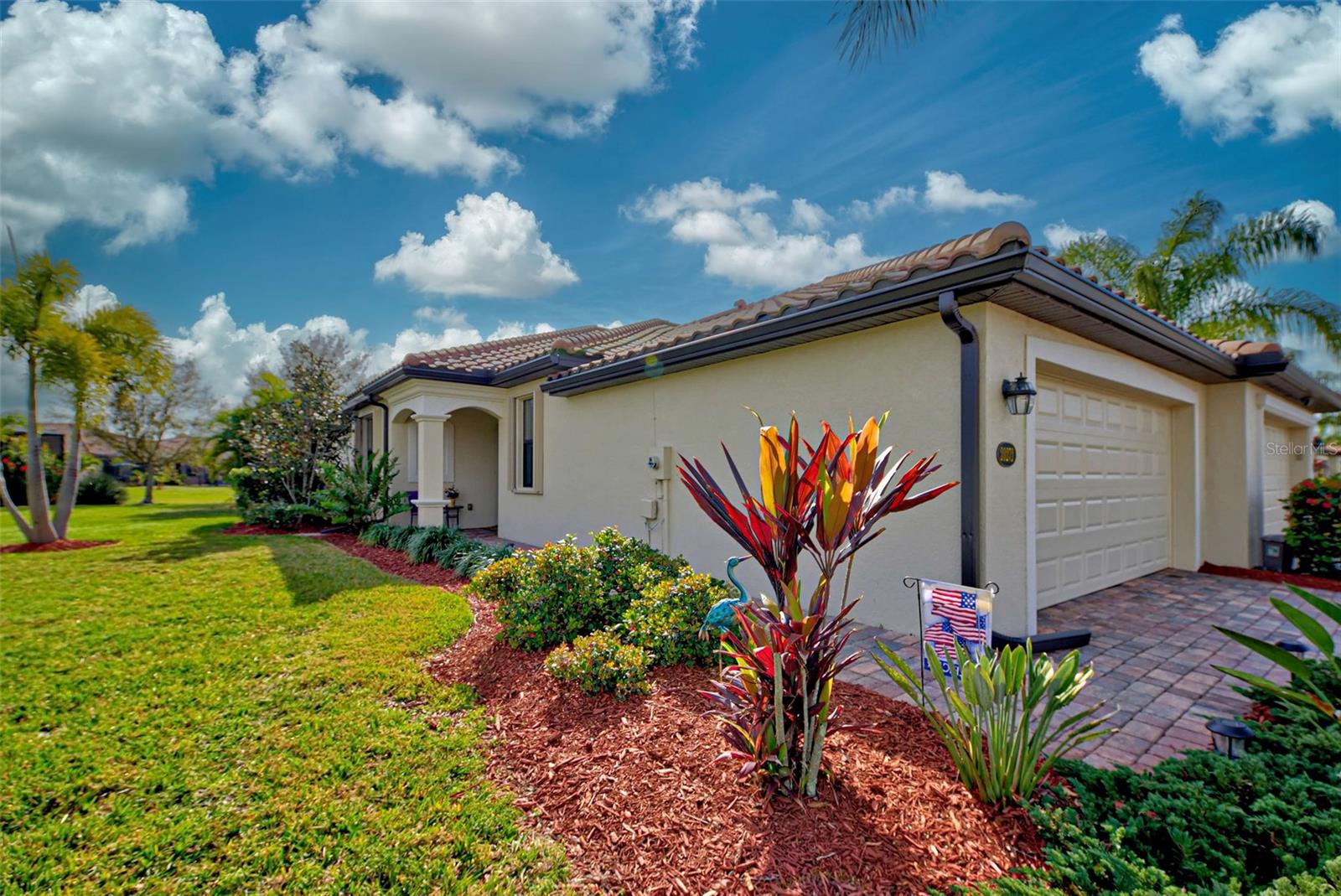 Check out the beautiful pond view and experience the ultimate in Florida living from the comfort of this exquisite villa within the maintenance-free resort community of Gran Paradiso. Embrace the Orchid model's thoughtful SPLIT FLOOR PLAN design, TWO BEDROOMS AND A DEN with French doors, two baths and 2 CAR GARAGE. Check out the Updated two-car garage that has a StorPro OVERHEAD STORAGE SHELF and a NewAge GARAGE STORAGE CABINET/WORK BENCH with TWO ROLLOUT TOOL BOXES. This home has beautiful finishes such as crown moldings, granite countertops, and diagonally tiled floors, complemented by stainless steel appliances in the kitchen. A new water heater was installed in 2023. NO WORRIES putting up HURRICANE SHUTTERS this villa is equipped with a ROLL DOWN SHUTTER ON the LANAI and ACCORDIAN SHUTTERS ON EACH WINDOW. Situated on one of the FEW OVERSIZED LOTS in Gran Paradiso, this villa offers ample green space and extra space between the villas. Indulge in the resort-like array of amenities, including community activities, a rejuvenating pool, saunas, steam rooms, gym and workout facilities, PICKLE BALL and tennis courts to name a few. Or simply unwind while admiring the pond and the beautiful array of birds from your lanai. Located close to Beaches, shopping, the Braves Winter Training facility and lots of great dining Choices! Call today for your private showing and elevate your living experience in Gran Paradiso's premier community.