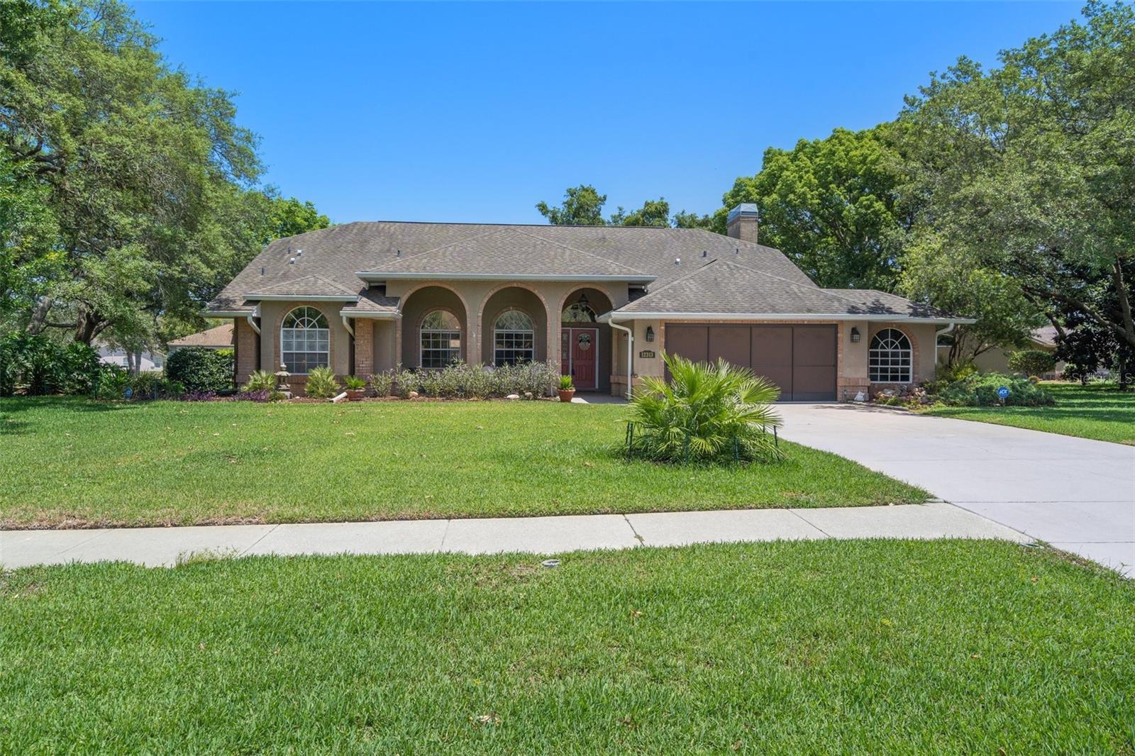 Active Under Contract – Accepting Back Up Offers. Welcome to Knotty Pine Ct, where luxury meets comfort and style. This magnificent 3-bedroom, 2-bathroom, 2-car garage pool home is located in the prestigious Preston Hollow subdivision on over half an acre of land with majestic mature tree's. As you step into this stunning home, just beyond the foyer, you are greeted by the spacious and light-filled kitchen that features granite countertops, a center island, high end cabinets, stainless steel appliances, and a large double pantry. The kitchen flows seamlessly into the family room that boasts a cozy fireplace and creates a perfect space for gatherings and relaxation.
The large living room is equally impressive with a beautiful and modern wood plank wall, adjacent to the dining room, creating a warm and inviting atmosphere for family and friends to enjoy. The master bedroom is a true oasis with two walk-in closets and a large luxury master bath that features a double vanity, a jacuzzi garden tub, a stand-alone shower, and water closet with glass doors.
The floor plan is split, with the two guest rooms being on the other side of the house, and the guest bathroom is conveniently located next to one of the many pool entrances.
The sparkling pool is a true masterpiece, surrounded by a screen cage and a large lanai space, providing plenty of room for lounging and enjoying the best of Florida's sunny weather. The pool has been refinished, and the pool heat pump keeps the pool warm all year (lower cost to heat than a traditional pool heater). In the yard the sod was installed last year, creating a lush and inviting landscape. With the private irrigation well and the irrigation system (which was completely overhauled last year) they ensure that your lawn stays healthy and green all year round.
The garage is a car lover's dream, with a newer screen and a bump out for a golf cart, which is being used as a small shop. The garage also has a dog run access, making it easy for your furry friend to enjoy the outdoors. The driveway has been recently painted, and the garage floor has been painted with acrylic, making it look brand new. All the carpet has been replaced, and tile has been installed in the living room, dining room, kitchen and both bathrooms. The family room features wood planking type flooring, adding to the charm and elegance of this stunning home.
Every inch of this home has been touched, making it an absolute gem in the Preston Hollow subdivision. Whether you're relaxing by the pool or entertaining guests in the spacious kitchen, this home offers the perfect balance of luxury, comfort, and style. Come see for yourself what makes Knotty Pine Ct the perfect place to call home.