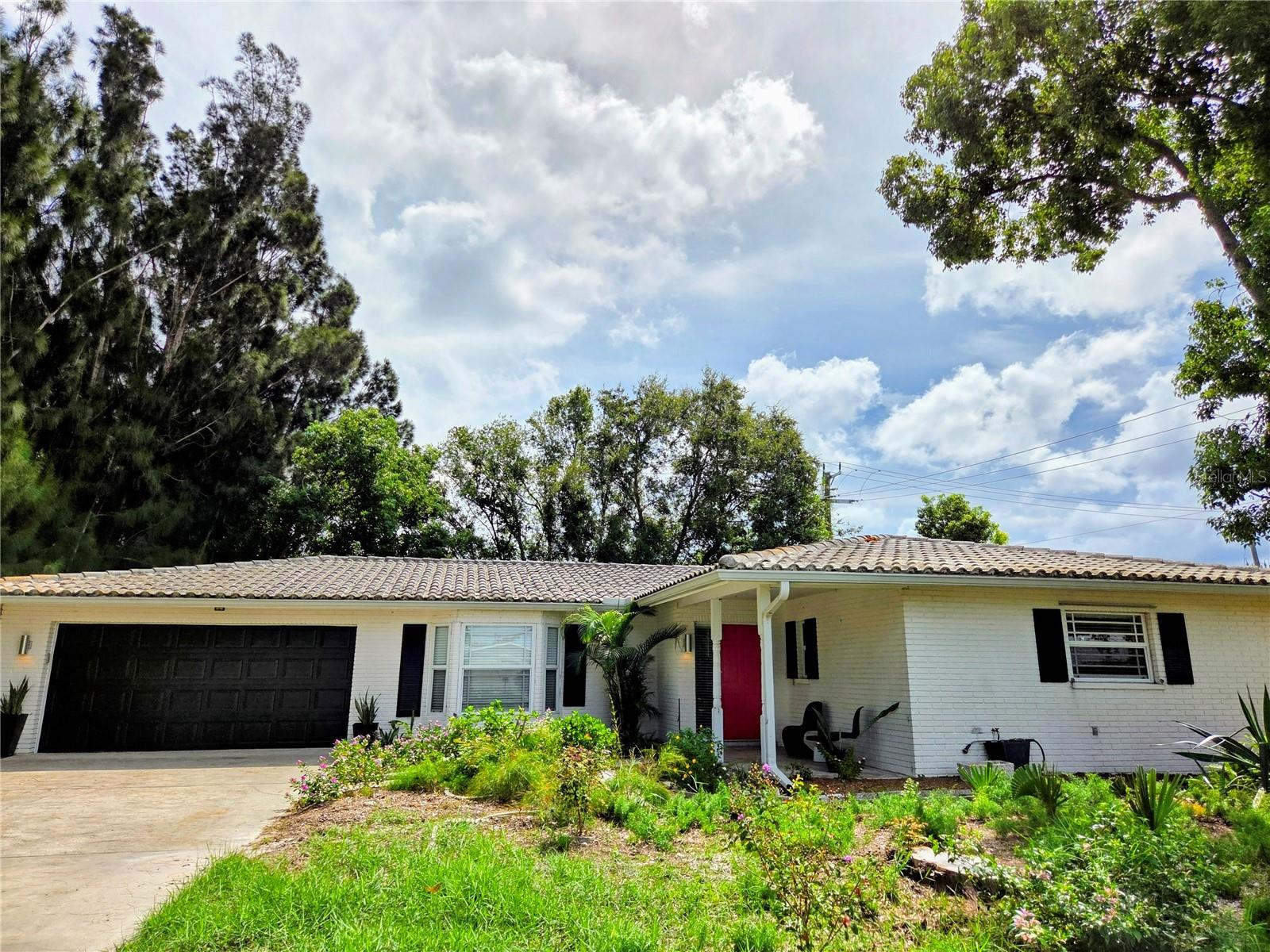 Beautiful updated 2000 sq ft South Gate home. 3 bedrooms with 2 walk-in closets & 2 beautifully updated bathrooms. This professionally updated open kitchen floor plan is so welcoming that friends will love to gather around the amazing granite waterfall peninsula. The two-toned wood cabinet kitchen was designed with ample drawer/storage and boasts quality matching stainless energy efficient Maytag appliances. This gem has beautiful luxury vinyl plank flooring throughout. You will have plenty of storage or craft space in the oversized indoor laundry room. Set up your entertainment room and relax under the fan in the large enclosed Florida room. Park your car in your two car garage. Shady treed 1/4 acre+ lot completely fenced in. Barrel tile roof and newer hurricane windows keep cooling costs low. Property owner includes routine heating & cooling maintenance, quarterly pest control and weekly landscape maintenance. Some photos are older photos from previous tenants.