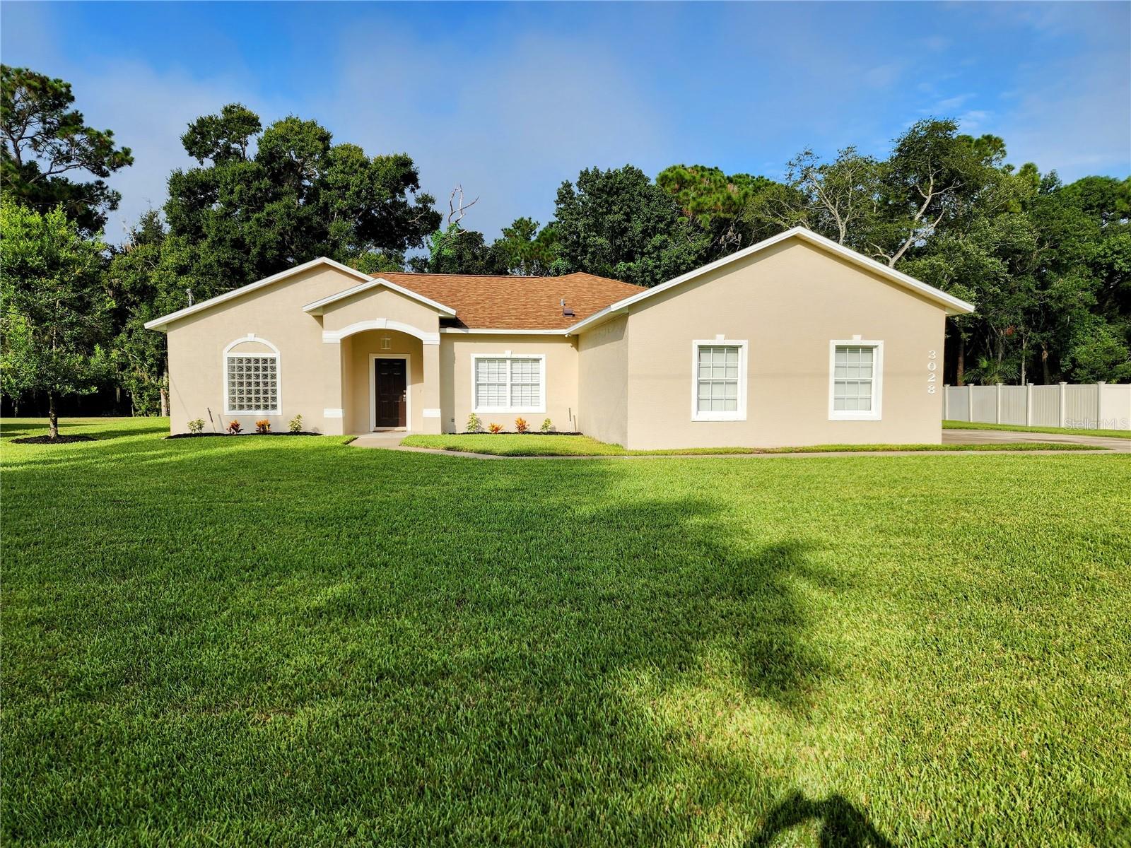 Beautifully updated block 4BR/2BA pool home in the sought after Florida Shores Community of Edgewater, set on a spacious triple lot just minutes from the intercoastal, indian River, and the sandy beaches of New Smyrna. This convenient location offers easy access to boating,fishing, dining, schools, airports, and I-95, making it the ideal blend of lifestyle and practicality. The town of Edgewater is also in the final stages of installing underground utilities a major neighborhood Improvement that will enhance curb appeal and property values.
The large lot provides plenty of parking areas for RVs boats and multiple vehicles also provides room for an additional garage shop building. Flowing canal in back yard is home to fish, turtles, and birds Covered pool area a great place for cooking out entertaining guests, fire pit behind house. property sits high and dry never flooded New garage door and garage door opener for the two car garage, you have a large laundry room with plenty of storage and laundry sink, vaulted ceilings in great room, kitchen, and dining area, bedrooms and bathrooms
have 9 ft ceilings, kitchen area has been updated with quartz countertop including bathrooms quartz countertop, new flooring in main living area and bedrooms . A/C replaced this year roof was 2019