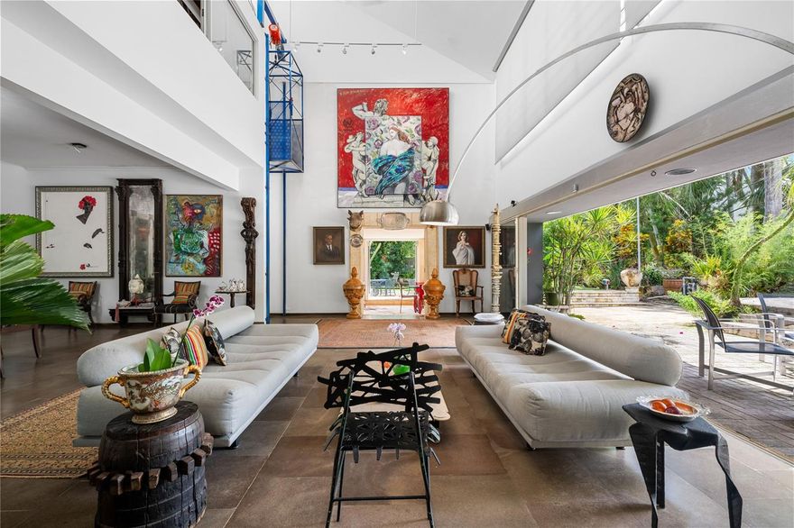 Welcome to this stunning architectural jewel in Garden Hills, a unique masterpiece with a double lot (approximately half an acre*), designed by a renowned architect showcasing a harmonious blend of urban elegance and modern functionality, offering an unparalleled retreat just moments from the city and a few steps to the Caparra Country Club. The house sits on one of the largest lots in Garden Hills. Situated in a very private dead end street, in a gated community, the residence is in Garden Hills, one of THE most exclusive coveted neighborhoods in Guaynabo and the San Juan metro area. This thoughtfully designed home features an open-concept floor plan perfectly integrating the ample dining area to the majestic Great Room with its soaring double height cathedral ceilings, all seamlessly flowing to the 3 terraces surrounding it in every corner. The perfect flow between the indoor and outdoor living areas connects all three terraces to the tranquil koi ponds and the striking infinity pool in the center, providing a peaceful and serene oasis, yet also ideal for hosting and entertaining large gatherings.  The home also boasts 3 bedrooms all with a baths and a fourth bonus, or caretaker’s bedroom with an en-suite bath, a family room, a powder room and an office with a separate entrance overlooking the scenic gardens. The master bedroom has its own private terrace with an outdoor pool/spa also overlooking the lush gardens. The chef’s kitchen combines sleek finishes with functionality and opens to another terrace and small pond, making it ideal for intimate gatherings. The office faces another terrace with an oriental style pond filled with water lilies, adding a unique peaceful and inspiring work area to the room. All is complemented with more luxurious details such as abundant natural light, fresco paintings, a 1000 bottle wine cellar, stone floors, an elevator, stained glass windows, a 2 car garage, a generator and a cistern.
*This house has 2 adjacent separate lots of 980s/m and  900s/m forming the beautiful gardens of the house, together making it one of the largest lots in Garden Hills.  
This contemporary sanctuary is only 12 minutes from San Juan and right next to some of the best schools, great restaurants, superb shopping venues and excellent sport facilities, combining suburban and city living at its best. Also available for RENT.