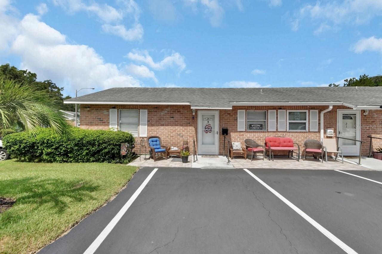Welcome to Fairway Village, a vibrant 55+ POOL and Clubhouse community nestled in the charming city of Deland. This beautifully decorated corner unit condo offers 2 bedrooms, 1 full bathroom, and 1 half bathroom, providing a comfortable and convenient lifestyle living experience. Upon entering, you'll be greeted by a meticulously maintained and updated living space. The kitchen has been updated with modern appliances, plenty of cabinet space, and a convenient breakfast bar. The home has luxury vinyl laminate flooring throughout the main living areas. The back porch has been closed in with new double pane window and insulated roof. Step out your back door and the pool is right there for your enjoyment. The primary bedroom is spacious with a spacious closet. The second bedroom is versatile and can serve as a guest room or home office. The guest bathroom tub has been retrofitted with a step in for safety and convenience when showering. This unit has it's own Washer and Dryer located in the 2nd bedroom closet area and vents outside. The front patio area has the perfect peaceful spot for enjoying morning coffee or visiting with neighbors. Rails were added to the front door entrance area for added safety. Located in proximity to convenient shopping centers, restaurants, award winning Downtown DeLand and home of Stetson University, and healthcare facilities, ensuring convenience lifestyle. Newer AC unit, Water Heater, and undated Panel Box. All you have to do is turn the key and you are home.
