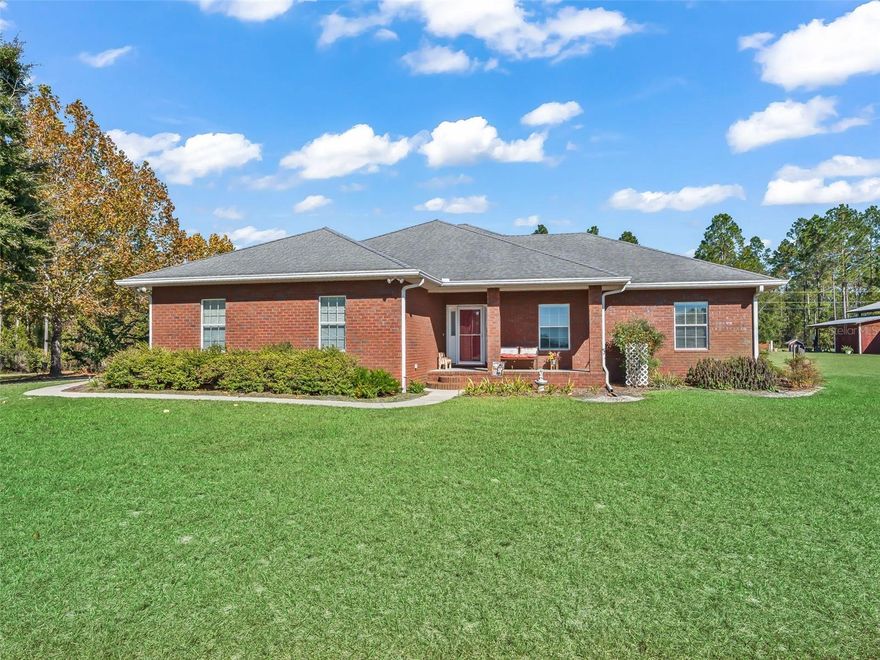 Distinguished 20-Acre Farm with Elegant Custom Brick Home where Comfort meets Class! 
Unrestricted country freedom awaits on this beautifully maintained property with plenty of room for everyone on this exceptional farm so bring the Horses, Chickens, Livestock & More!! Built to last, this brick ranch home blends refined craftsmanship, quality construction and true country living. Inside you’ll find an open floor plan featuring solid-surface Corian countertops, wood cabinetry, hardwood floors, tray ceilings, built-in propane for fireplace, spacious kitchen with ex-large walk-in pantry providing exceptional storage!! Additional features include whole-house vacuum, water treatment system, crown molding, ceiling fans, high ceilings and quality double pane windows including window treatments throughout.
The primary suite delivers space and comfort with a large walk-in closet, double sinks, a private water closet, and a walk-in shower. The 2-car garage provides ample workspace and additional storage as well.
The open kitchen with island bar flows into the dining and living areas, making it ideal for everyday living and entertaining. Enjoy peaceful mornings and evenings on the large, screened back porch, or take in the sweeping pasture views and stunning sunsets from the charming front porch.
Outside the property is manicured with mature landscaping, fruit trees, pine trees, lush pastures and sidewalks surround the home to keep things neat and tidy!  The pole barn has 2 workshop areas and lots of room for storing equipment, holding family functions or could be converted easily into a gorgeous horse barn.  Enjoy fresh eggs...the Chicken Coop is a wonderful feature to this property and fully equipped with easy access to the Hen House with water supply adjacent for convenience! Just minutes from town, shopping, dining, medical care & The Suwannee River, yet worlds away from noise and congestion! NO HOA, NO restrictions! Your private country estate is ready-schedule your tour today!!