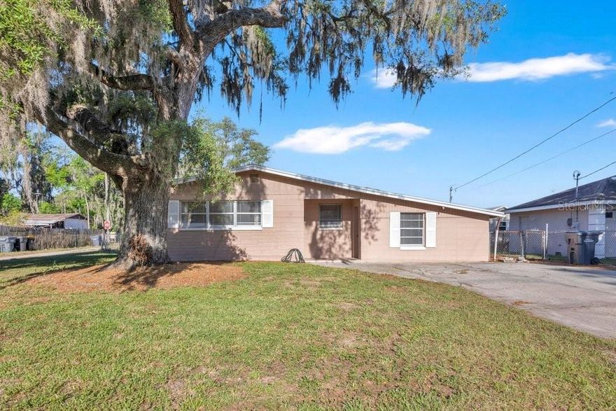 Move-in ready, this charming 3-bedroom, 1-bath block home sits on a spacious lot with no rear neighbors, offering added privacy and peaceful surroundings. Inside, you’ll find updated flooring in the bedrooms and bathroom, creating a fresh and inviting feel. The home also features two versatile bonus rooms—perfect for a home office, in-law space, or even a possible 4th bedroom to suit your needs. Enjoy Florida living at its best with a screened lanai off the back, ideal for relaxing in the sunshine or entertaining guests year-round. With its flexible layout and generous outdoor space, this property offers both comfort and opportunity. Whether you're a first-time buyer or looking to expand, this home is ready for you to move right in and make it your own!
