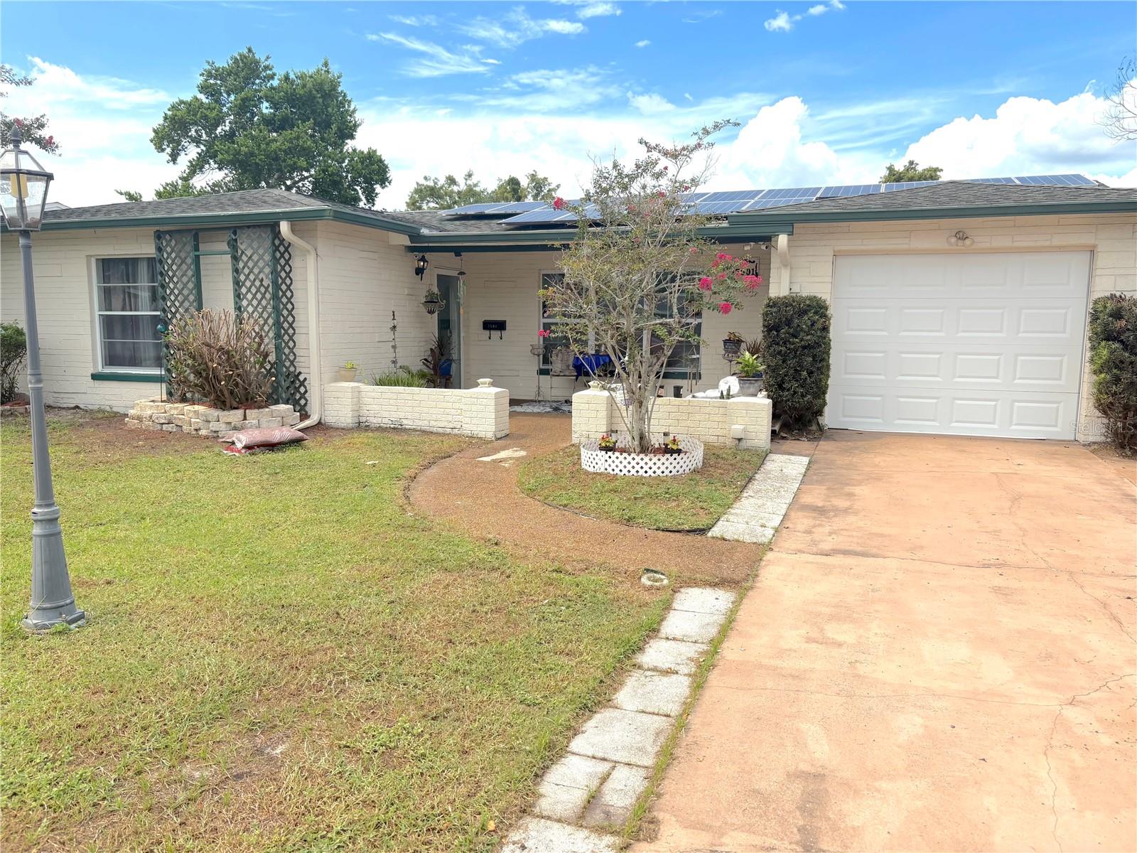 Word on the street is rates are dipping—connect with your lender to see if you’re qualified to benefit from this rate adjustment.
Nestled in the tranquil and highly sought-after Magnolia Valley, just 5 minutes away from the vibrant downtown New Port Richey, this stunning 3-bedroom, 2-bathroom residence is a true gem. Boasting luxurious updates and modern design, this home exudes both elegance and comfort at every turn.
The kitchen has been expertly updated with French Provincial-style solid wood cabinets, complete with built-in lighting, a custom wine rack, and sleek granite countertops that add sophistication to the heart of the home. Updated vinyl plank flooring spans all the main living areas, laid diagonally for an enhanced sense of space and flow. The open concept living and dining rooms create a welcoming atmosphere, perfect for both relaxing and entertaining.
Relax in the spacious family room, where you'll find a cozy wood-burning fireplace, built-in shelving, and dimmable lighting to set the perfect mood. Whether you're winding down after a long day or hosting friends, this space is designed for comfort and versatility.
The owner's suite is nothing short of magnificent! This elegant retreat includes a queen-sized closet with custom shelving and a vanity, offering ample storage and a place to prepare for the day. You'll also enjoy a second walk-in closetand a private en-suite bathroom, complete with a beautifully tiled shower stall—making it your own personal spa. The second bedroom also features a walk-in closet for added convenience.
Need more space? The converted garage offers a third bedroom with its own private entrance, ideal for guests, a home office, or extra privacy. Additional garage space remains, perfect for storing lawn equipment, bikes, or toys.
This home is as energy-efficient as it is beautiful, with newer windows and owned solar panels on the roof, helping to reduce energy costs.
The home offers a security system and a fully operational sprinkler system.next we go to the screened in porch area which a perfect place to relax and drink your morning cup of coffee. This leads Out back, the maintenance-free backyard is fully fenced, offering a private oasis. A composite wood deck provides the perfect space for outdoor gatherings or quiet relaxation. This is truly a move-in-ready home with all the updates you desire.
Don't wait! This beauty won't last long. Schedule your showing today and experience everything this home features!