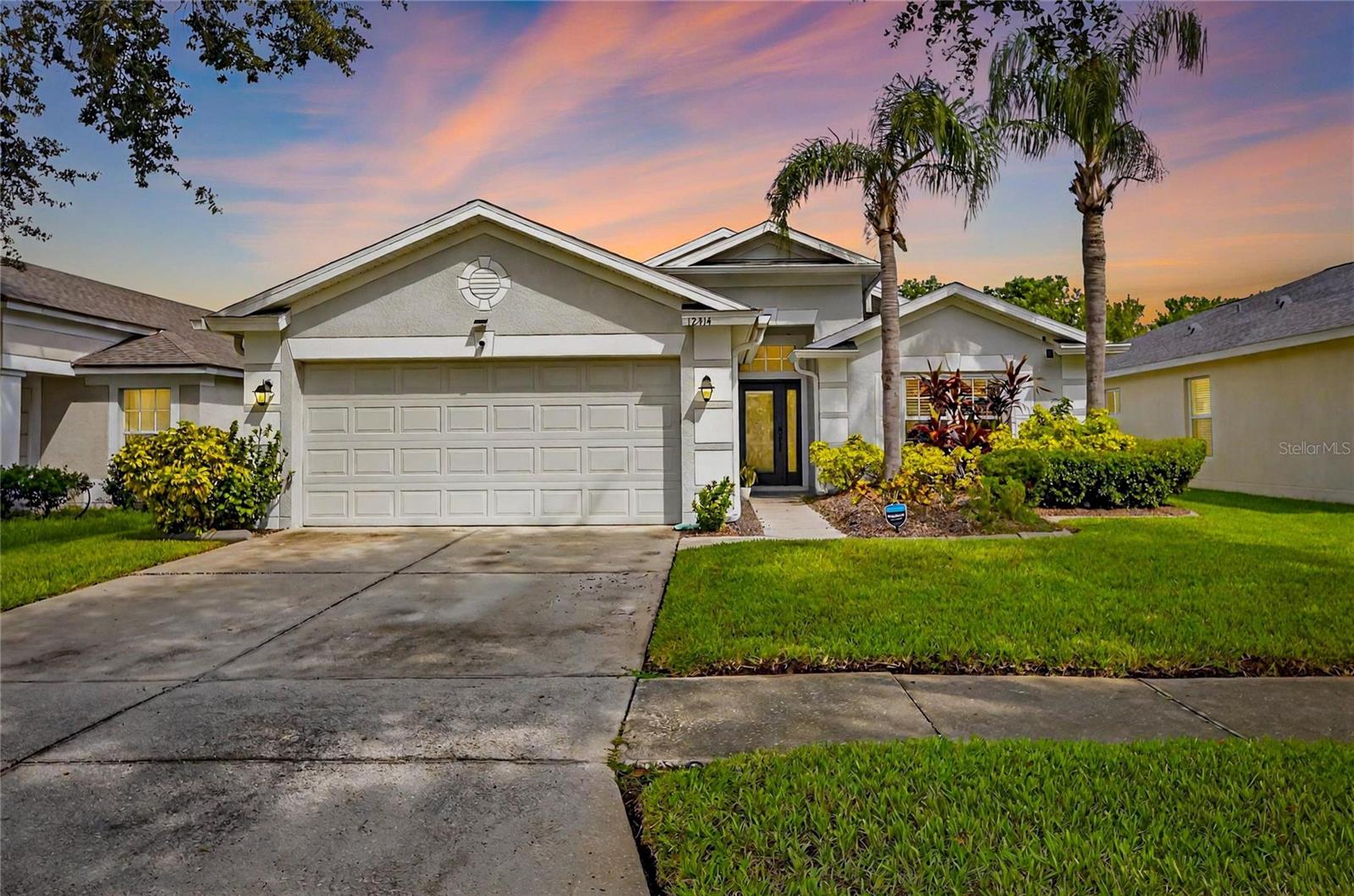 Welcome home to this impeccably maintained 4-bedroom, 2-bath residence nestled in the South Cove community. The home showcases an inviting open floor plan where the living and dining areas flow seamlessly together, creating a welcoming space for you to gather and entertain. Interior highlights include updated lighting and fans, as well as durable tile and wood laminate flooring throughout for easy maintenance. The kitchen is equipped with modern appliances and a cozy breakfast nook, perfect for morning coffee or casual meals. Private primary suite features a walk-in closet with built-ins, and an en suite bath complete with a garden tub, separate shower, and expanded vanity with dual sinks. Three additional bedrooms in the split floorplan provide ample space for household members or guests, served by a second full bath. Step through sliding doors to your own backyard haven. A heated pool and spa surrounded by lush tropical landscaping invite you to relax year-round. The covered lanai offers shade for outdoor dining and entertaining, while a peaceful pond view enhances the tranquil ambiance. Lawn care, pool service, and pest control are all included, allowing you to simply enjoy. Located in South Cove, residents enjoy their own community pool and playground, plus access to the Summerfield master community amenities. These include multiple pools, tennis and basketball courts, a fitness center, dog park and playground—perfect for an active lifestyle. The home also comes with a two-car garage and is conveniently close to shopping, dining and commuter routes.