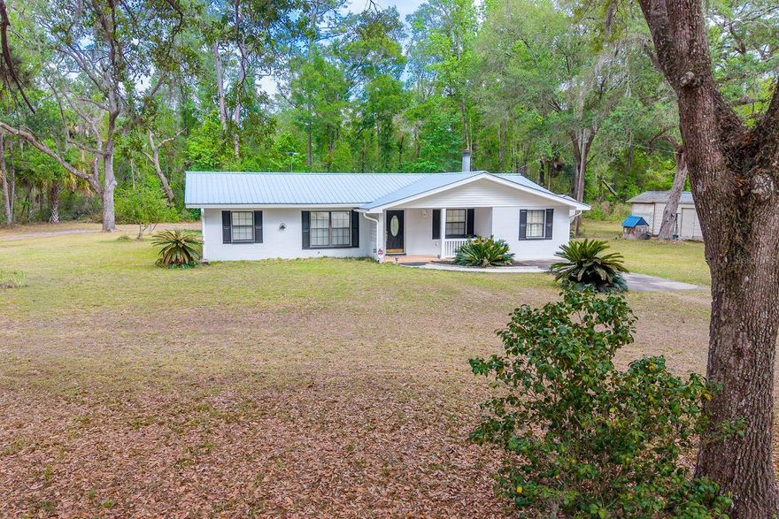 Welcome to this charming 3-bedroom, 2-bath concrete block home situated on 1.28 acres in the peaceful community of Old Town. Conveniently located just off Highway 349, this property offers the perfect blend of accessibility and quiet country living in North Florida. The home features a functional layout with comfortable living spaces and a screened-in room, ideal for enjoying the outdoors year-round without the nuisance of insects. A covered 2-car carport provides convenient parking, while a detached one-bay garage and two additional storage sheds offer plenty of space for tools, equipment, or hobbies. Step outside and enjoy the natural beauty of the property, complete with mature grapefruit and orange trees that add both charm and seasonal enjoyment. The expansive backyard provides a peaceful setting where deer are often seen passing through, creating a true connection to nature. Located in Dixie County, Old Town is known for its laid-back lifestyle, proximity to the Suwannee River, and easy access to outdoor recreation including boating, fishing, hunting, and kayaking. It’s just a short drive to the Gulf of Mexico, making it an ideal spot for those who enjoy both freshwater and saltwater activities. The area offers a quiet, rural atmosphere while still being within reach of nearby towns for shopping, dining, and everyday conveniences. Whether you're looking for a full-time residence, a weekend getaway, or an investment opportunity, this North Florida property delivers space, functionality, and a peaceful setting.