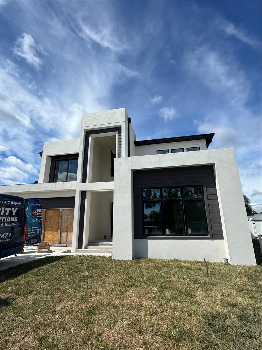 One or more photo(s) has been virtually staged. Under Construction. Welcome to 4316 Wallace Cir – a beautifully crafted 4BR/3.5BA home offering 3,098 sq ft of modern luxury and thoughtful design in the heart of South Tampa. From its striking white exterior with bold architectural accents to the lushly landscaped front yard with vibrant purple blooms and a stylish white fence, every detail of this property exudes sophistication and curb appeal. Step inside to discover soaring 10-foot ceilings, expansive PGT impact windows that flood the space with natural light, and a spacious 2-car garage. Upstairs, a generous loft provides the perfect space for a home office, game room, or media lounge - tailor it to fit your lifestyle. The fully fenced backyard is ideal for entertaining and offers plenty of room for a pool, creating endless possibilities for your private outdoor oasis. Best of all, no flood insurance is required - offering peace of mind along with unbeatable style. A second-floor balcony adds a touch of architectural elegance, while inside, luxury custom finishes from the Priano Design Center will be sure to impress. Located in a prime South Tampa neighborhood, this home offers easy access to top-rated schools including Lanier Elementary, Monroe Middle, and Robinson High School. Enjoy close proximity to the vibrant Westshore Marina District, downtown Tampa, MacDill Air Force Base, and scenic waterfront parks. Experience the perfect blend of luxury, functionality, and location in one of Tampa’s most desirable communities. Schedule your private showing today and envision the lifestyle that awaits at 4316 Wallace Cir! Up to 1% towards closing costs with seller's preferred lender!