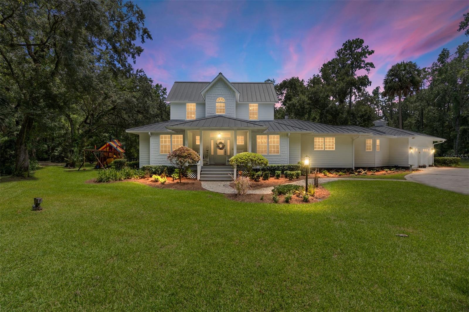 3.5 acres of Paradise in town! Own a Jerry Stevens designed masterpiece with a pond. Enjoy privacy and serenity of rural country living, just minutes to the World Equestrian Center. This home sits on one of the most gorgeous and convenient 3.5 acre parcels in Ocala. The wooded border and a three board with no climb fence around perimeter and the front electric gate maintains the privacy and secluded feeling, though just a few minutes drive to Publix, Lowes, etc. Unwind on the screen porch overlooking the water. This magnificent home offers over 2700 sq ft of air-conditioned space with entertaining in mind.Wide plank hickory floors, granite, LED lighting, crown and base boards, Pro Closet designed closets are just some of the superior features of this home. The expansive kitchen is open to the family room where you can enjoy spending time with your family and friends while still accomplishing your everyday tasks. An abundance of windows allows the natural light to brighten up the inviting family room that features a two-sided gas fireplace, built in shelves and cabinetry, and Cerwin Vega surround sound. The owner's suite features a beautifully crafted bathroom with a luxurious oversized walk in shower for two, freestanding soaking tub, and double vanity. Outdoors there are two paddocks and two stalls for your equestrian needs. Trails throughout the property along with plenty of space to store the toys. There is an attached two car garage, detached oversized 840 sq ft two car garage, plus a 26x40 RV/boat metal building with 50amp hookup, concrete floor, 16 foot roll up doors, ventilation and electric with separate drive. NEW 16 X 48 Pole Barn. The pond is exceptionally low maintenance and is stocked with Bream and Bass. It has a two-inch pipe with easement to DRA for controlling the water level and it has an aerator and a fountain. On those lowkey nights you will enjoy sitting under the stars by the paver firepit and patio.