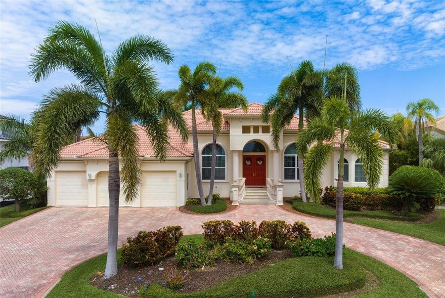 Welcome to waterfront living on one of the most desirable streets in Bird Key. A circular paver drive enveloped by lush mature landscaping frames the façade, as a double-door entry leads the way inside to its spacious and open floorplan with high ceilings in living room, dining room, family room and kitchen. The family room and breakfast nook area flow into the kitchen, boasting views of the pool area, with another set of sliders accessing the lanai. Sliding glass doors surround the area so views of the canal and pool can be seen from the heart of the home. This spacious home features 3,400+ sq ft, a 11+ ft elevation built in 2003 by Pruitt Builders. This home features a split floorplan with the primary bedroom sporting a 12-foot tray ceiling. Sizeable laundry room, beautiful office, and a 3-car garage. A boat dock with electricity and water, sailboat-deep water, a 16,000 lb boat lift. Bird Key living is the epitome of convenience as you are close to Lido Beach, dining, shopping, restaurants, and the events at St. Armand Circle. Just over the bridge is downtown's fine shopping, world-class dining, cultural activities, A-rated Schools, and Sarasota Memorial Hospital, one of Americas best hospitals. Experience the perfect location and waterfront living at its best!
