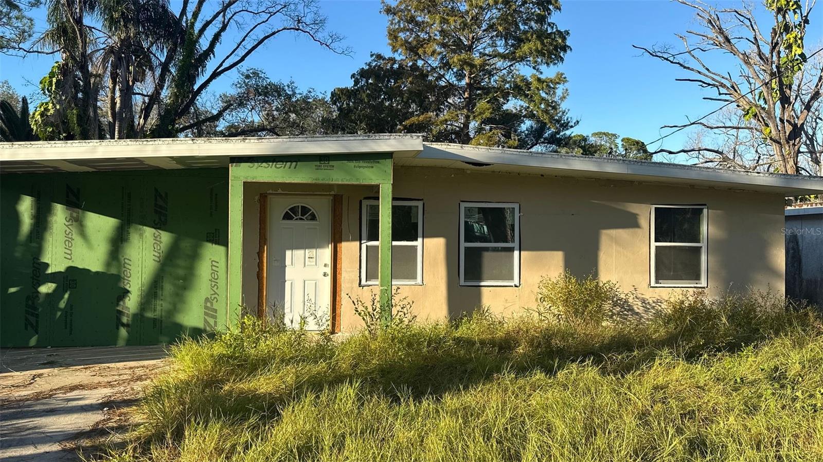 INVESTORS AND FLIPPERS- this one’s ready for the finish line. Solid block home with major updates and a workshop, offering nearly 1,100 sq ft of living space in the heart of New Port Richey. The 3-bedroom, 2-bath layout includes a garage conversion and features vaulted beamed ceilings that add character and space. RECENT UPDATES INCLUDE: new tile flooring, updated electrical, new A/C with ductwork, new roof, new framing, new front door, and several new windows. Both showers are already finished, giving you a head start on completion. All major systems are done- just bring the final touches and cash in on a high margin flip or long-term rental opportunity for landlords.