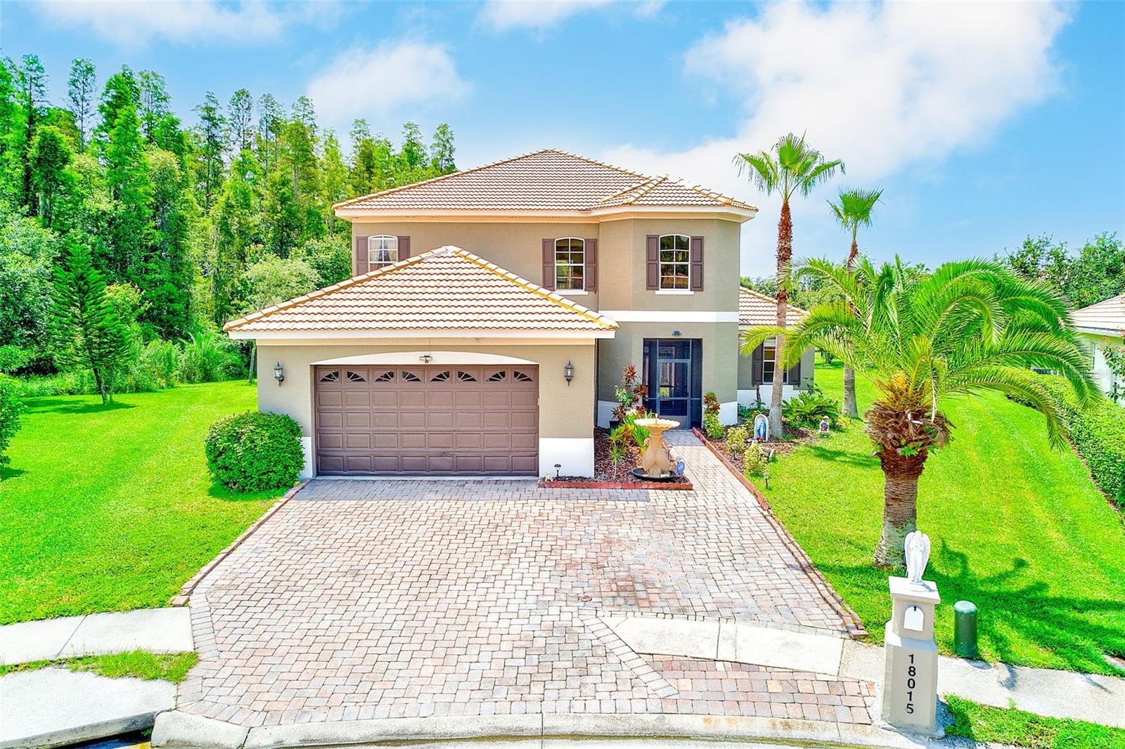 Tucked at the end of a quiet cul-de-sac and backing to peaceful conservation, this beautifully appointed 4-bedroom, 3.5-bath pool home offers 3,283 square feet of space, style, and serenity on an expansive 1/3-acre lot in the highly sought guard-gated community of Cory Lake Isles. With a tile roof, newer HVAC system, and an oversized screened lanai host to the saltwater pool, this home offers comfort, elegance, and lasting value.
Step inside to soaring ceilings, gleaming real wood floors, and abundant natural light pouring through large windows and transoms. Hardwood flooring flows throughout the great room, dining room, first-floor primary suite, and continues upstairs to the hallway and open catwalk, creating a sense of warmth and continuity. Two of the upstairs secondary bedrooms have been updated with luxury vinyl plank flooring, leaving just one room with carpet.
The dramatic two-story foyer and curved staircase make a striking first impression, leading into an expansive living space anchored by a spacious granite kitchen featuring built-in double ovens, a center cooktop island, café-style cabinetry, and a designer tile floor. The first-floor primary suite is a private retreat with dual walk-in closets, a luxurious bath, and even a built-in floor safe.
Located in one of New Tampa’s most sought-after communities, Cory Lake Isles offers resort-style amenities including a 165-acre ski lake with boat launch, sandy beach, lakefront clubhouse, fitness center, playgrounds, and sports fields. Zoned for top-rated schools and just minutes to hospitals, USF, and major commuter routes—this is a rare opportunity to own a refined home in an unbeatable location.