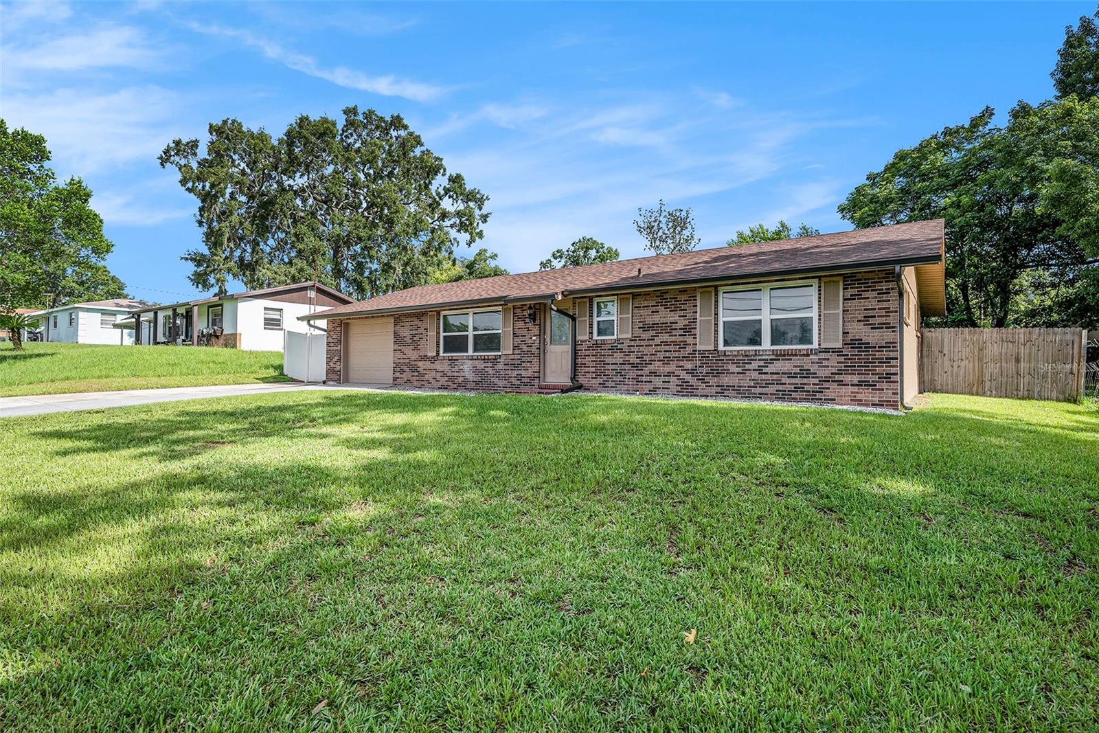 Well-maintained 2BR/2BA home with separate 1BR/1BA garage apartment on nearly ½ acre in a quiet, no-HOA area. Luxury vinyl plank flooring (2021), shingle roof (2025), HVAC (2014). Garage apartment has a private entry, full kitchen, and separate utilities—great for guests or rentals. Spacious yard with room to expand. Convenient to I-75, Tampa, and Ocala. Flexible property with income potential—schedule your showing today!