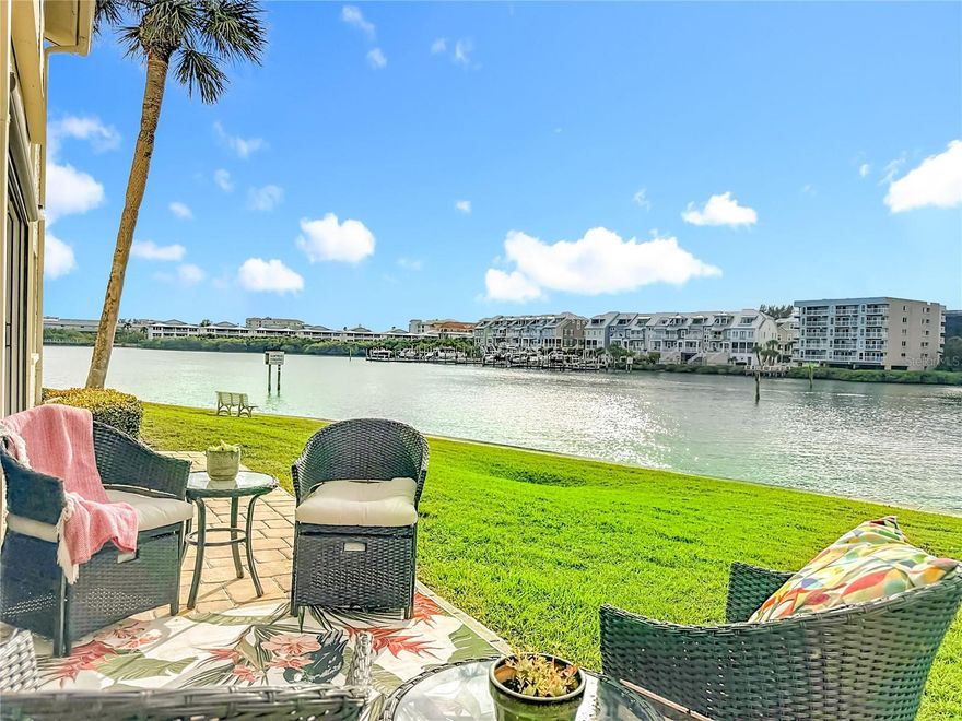 Welcome to your own Waterfront Paradise! This charming first-floor condo is designed for those who crave coastal comfort and convenience, offering direct access to the Intracoastal Waterway just steps outside of your back door. Rarely available, this residence is located in a small, two-story condo building—ideal for those seeking privacy, limited neighbors, a quiet coastal setting, and ample guest parking. The open floor plan features two bedrooms and two full baths, with a picturesque waterfront setting and a private back patio overlooking the water. Inside, the spacious living and dining area is thoughtfully designed for both comfort and entertaining. The updated kitchen showcases solid wood cabinetry, granite countertops, and a charming wine and bistro nook near the patio—perfect for morning coffee or evening relaxation. The open-concept layout seamlessly connects the kitchen and living space, offering flexibility for gatherings of any size. The generously sized primary suite offers two large closets, including a walk-in, and an en suite bathroom. Enjoy tranquil views of sailboats gliding by on the Intracoastal from your bedroom. A split-bedroom floor plan provides privacy, with a spacious secondary bedroom and adjacent full bath—ideal for guests. Additional highlights include an oversized in-unit laundry room, a designated covered carport, and additional storage conveniently located just outside the front door—adding everyday ease and practicality. A bright Florida room provides the perfect space to unwind while watching boats, dolphins, and glowing sunset skies over the water. Step outside to your private back patio, which serves as your personal waterfront retreat—ideal for relaxing, entertaining, or simply soaking in the peaceful surroundings. This home offers peace of mind with an elevated grade of over 8 feet (X500 flood zone) and no history of storm impact. At 1,400 square feet, this bright and contemporary condo is located in the prestigious, resort-style community of Imperial Point. Residents enjoy access to two pools, including a private condo clubhouse and pool for condo residents only. Just a short walk away are Imperial Point’s additional amenities, including a heated and cooled pool, picnic and barbecue areas, 24-hour fitness center, community clubhouse, game and billiards rooms, pickleball, bocce, shuffleboard, and 24-hour access to a fishing dock and boat ramp—all overlooking the Intracoastal Waterway. Recent updates include new tile flooring throughout, a new AC system and hot water heater (2025), hurricane-rated dual-pane slider doors and windows, updated lighting, and solid wood interior doors. Monthly association fees cover all amenities, internet, cable, Wi-Fi, water, sewer, trash, exterior maintenance, landscaping, and pool maintenance. Ideally located just minutes from Gulf beaches, shopping, dining, and local airports, this exceptional waterfront home offers a rare opportunity to enjoy Intracoastal living at its finest. Offered fully furnished if desired—so you can move right in and start living the coastal dream.