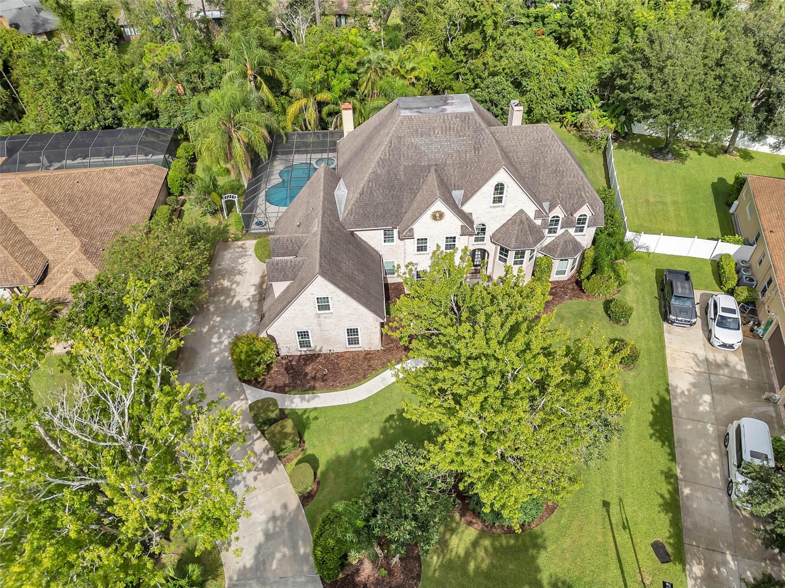 This Full Brick European style home with it's own private pool boasts plenty of living space and a modern renovated kitchen and gorgeous owners bathroom! Located in The Trails in Ormond Beach which is an upscale gated community that's more "private sanctuary" than anything cookie cutter, offers resort like amenities and the locals love it for good reason! Surrounded by nature preserve and green space, the enclave that is only minutes from the beach, shopping and the airport has walking trails, playgrounds, tennis, pickeball, basketball courts, community pool and more. Grand 2 story foyer with cat walk balcony leads up to Massive Owners retreat bedroom with fireplace and modern bathroom. Dual staircases allow easy access to the living space on main including office, dining, living, keeping room and more. The home has 3 fireplaces in Family, the charming keeping room off kitchen and owners retreat! Walk in pantry and loads of storage the floor plan wa thoughtfully designed for an active lifestyle. 3 Car Side Entry Garage completes the curb appeal of this striking family home with room for everyone!