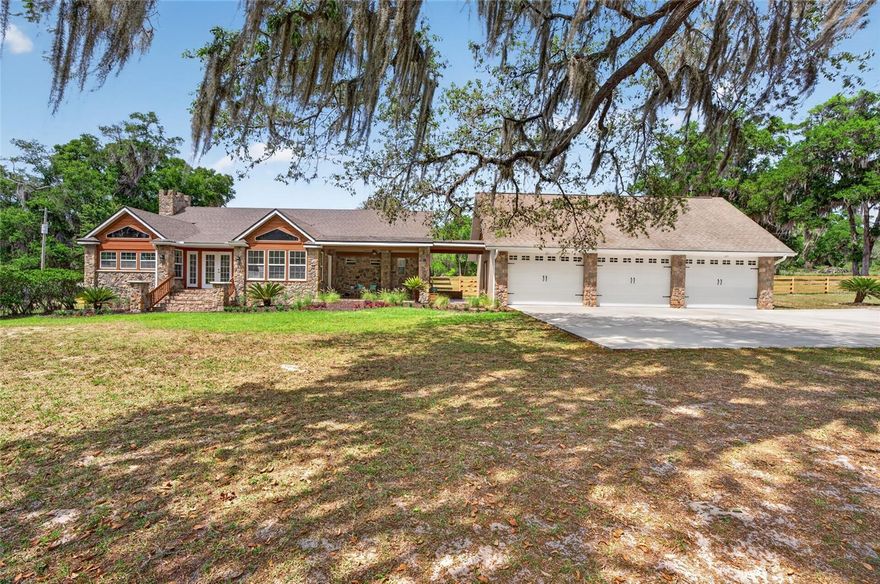 Private estate with lake views on Bull Pond offering exceptional privacy, acreage, and room for animals behind a custom gated entrance. This beautifully crafted Rambler-style home showcases striking stonework and quality finishes throughout. Inside features include a spacious granite kitchen, vaulted ceilings, wood-burning fireplace, dedicated office, and bright sunroom ideal for relaxing or entertaining. A large 3-car garage includes a versatile bonus room above--perfect for a studio, gym, or additional living space. The property also offers a separate ADU/guest house for visitors or extended family. Professionally landscaped and freshly painted, this home is move-in ready with new appliances, water treatment system, and serviced HVAC systems with warranty coverage through 2030. Enjoy deeded access to Bull Pond with a private dock and boat launch shared by only 10 owners.