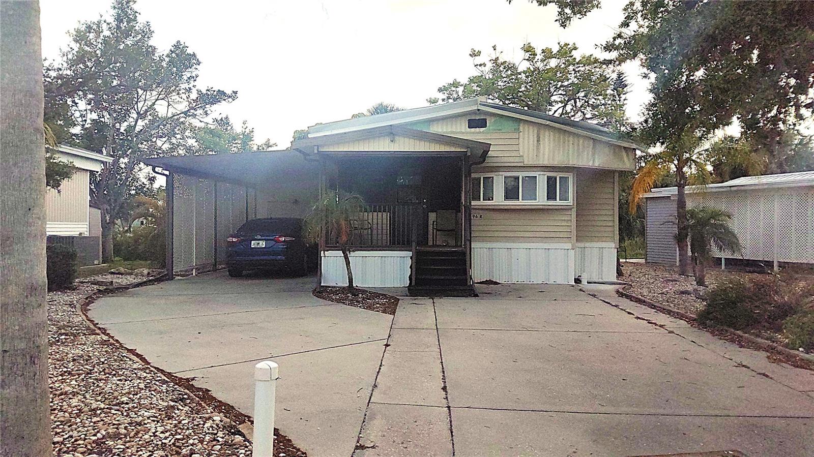 This home is right on Sugar Creek with a gorgeous view of the water. No back neighbors and plenty of greenery. The home is nicely updated. This 55+ community has many ammenities for your active schedule, including large heated pool, miniature golf, pickleball and tennis courts, a billiard room, library and clubhouse for all of the hosted activities. This home is high enough that it did not have any water intrusion, however the roof did sustain some wind damage. The current price reflects the property needing the metal pans on the roof repaired.