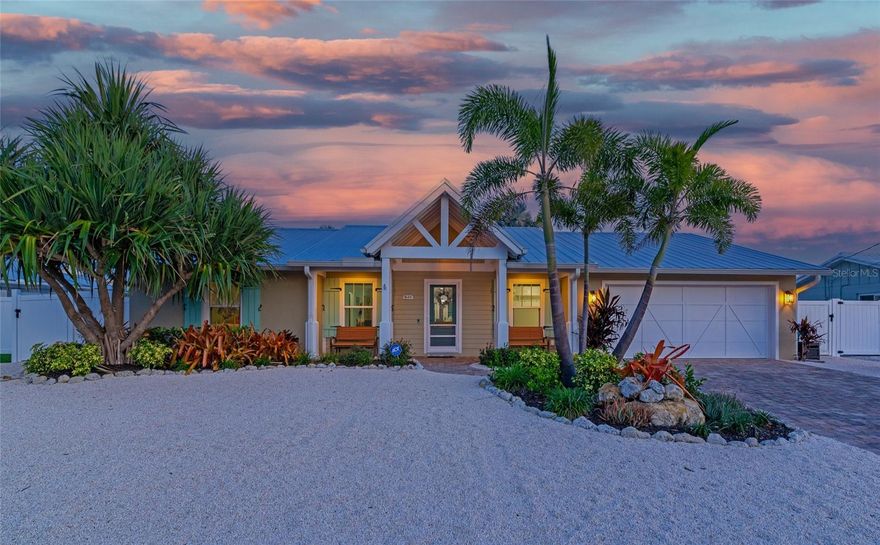 Experience island living with this canal front oasis in Holmes Beach on Anna Maria Island. Imagine waking up to manatees in the canal behind your home and enjoying a leisurely morning stroll along the pristine beaches just moments from your doorstep. Whether you're seeking a permanent residence or a seasonal retreat, this home offers a seamless blend of relaxation, luxury, and the laid-back charm that epitomizes AMI. Every day will feel like a vacation as you savor the tranquil ambiance, indulge in water activities, and create memories that will last a lifetime.

This stunning, completely renovated 3 bedroom plus a den, 3.5 bathroom residence is the epitome of casual luxury in waterfront living. A newer metal roof and impact windows and doors will give you peace of mind in hurricane season and in addition to low-maintenance tropical landscaping, will make caring for this home a breeze.

Step inside and you'll be captivated by the impeccable craftsmanship and attention to detail that went into every aspect of this home's renovation. The open floor plan seamlessly blends contemporary design with a coastal flair, creating an inviting and relaxing atmosphere throughout.

The gourmet kitchen is an entertainer's delight, boasting new stainless steel appliances, custom wood cabinetry, a large center island with plenty of room to gather, and granite countertops. The spacious dining room easily fits a table for 8 or more and the bar features a mini-fridge and ice maker.

The master suite is a private retreat, featuring lanai access, vaulted beamed ceilings, a walk-in closet, and a luxurious en-suite bathroom complete with a double vanity, and a glass-enclosed shower. The two additional bedrooms are generously sized and feature their own well-appointed bathrooms.

The outdoor space is a true oasis for relaxation and entertainment. The heater and pump on this salt water pool and spa were just replaced in 2022. Enjoy alfresco dining under the covered patio, or simply lounge by the pool while basking in the warm Florida sun.

For the boating enthusiast, this property is a dream come true. With a 10,000-pound boat lift and a double jet ski lift which has been recently reconditioned, you'll have easy access to the warm waters of the Gulf of Mexico and the Intracoastal Waterway, allowing you to explore the endless water adventures that await.

For your convenience, a propane tank fuels the tankless water heater as well as the pool heater. An outdoor shower makes it easy to keep the sand where it belongs. In the oversized garage you'll find a commercial ice maker, perfect for stocking your cooler for a day of fishing on your boat, as well as an additional refrigerator and freezer, ready to store the day's catch.

Additionally, you'll be in close proximity to vibrant restaurants, boutique shops, and a variety of recreational activities.
This home is being offered furnished, with a few personal items excluded. Specific inventory is available upon request. Seller is providing a home warranty from Americas Preferred Home Warranty for buyer's added added satisfaction.

Don't miss out on the opportunity to own this exceptional canal front home in one of Florida's most desirable locations. Indulge in the luxury of waterfront living and make this extraordinary property your own. Schedule your private showing today.