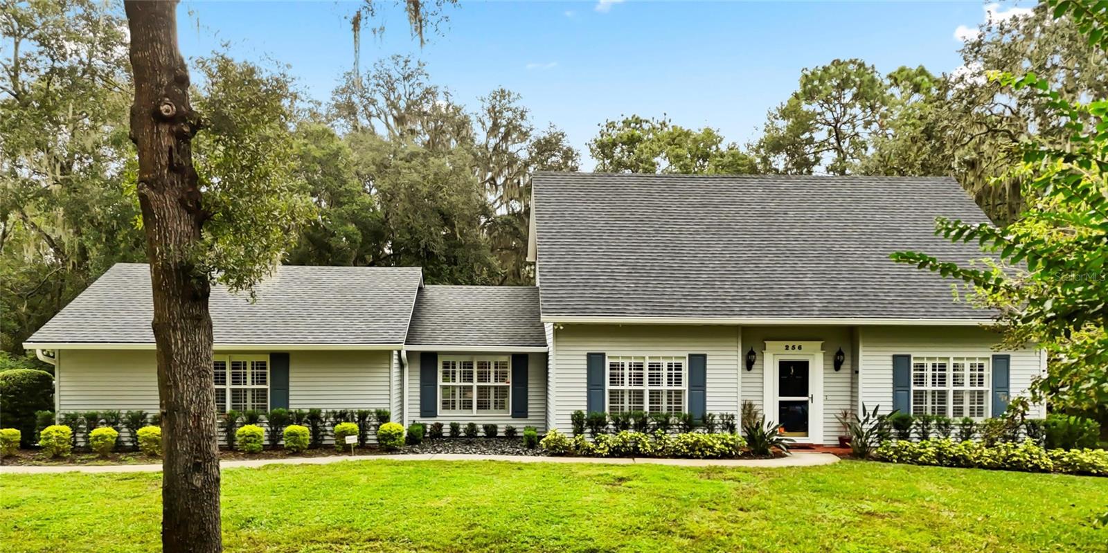 Step into timeless elegance with this beautifully updated & meticulously maintained home crafted by the renowned Dreggors Construction of DeLand. This 2-story Cape Cod-inspired home is perched atop a gentle hill in the heart of Trails West. With 2,160 square feet of thoughtfully designed living space, this residence lives large — offering the comfort and flow of a much bigger home. So many closets and storage areas that are all easily accessible. The current owner has updated the property to the highest standards including a New Roof 2025 & 18 Seer Lennox HVAC 2023. Inside, you'll find a winning blend of classic style and modern updates: granite countertops, stainless steel appliances, plantation shutters, crown molding, and beautiful luxury tile throughout. Kitchen cabinets have been upgraded with pull-outs. The formal living room is spacious and welcoming, while the dining room is a harmonious blend of function and charm and currently moonlights as a library. This room features French doors, a bay window and an abundance of light. The galley-style kitchen is a cook’s delight with generous counter space, two pantries, and a cozy eat-in nook overlooking your lush backyard oasis. Downstairs includes a private bedroom with en-suite bath and walk-in shower, plus a powder room for guests. Upstairs, a heated/cooled bonus room offers endless possibilities—home office, craft space, or storage galore—and is already partially plumbed for a future bathroom. Outside, the magic continues: mature landscaping with azaleas, camellias, and majestic oaks surrounds brick paver paths, a gazebo with swinging bench seats, and a large patio perfect for entertaining. Let's not forget the 2025 installation of a new well for irrigation. The oversized 2-car garage includes a sink, cabinets, insulated door, and even has plantation shutters. All of this nestled in a private, park-like setting with access to Trails West amenities: pool, tennis courts, clubhouse, basketball court, playground, picnic tables, and grilling area. Just minutes from downtown DeLand, Stetson University, shopping, and dining. Welcome home to comfort, character, and community—this Trails West treasure is ready to be loved by you!