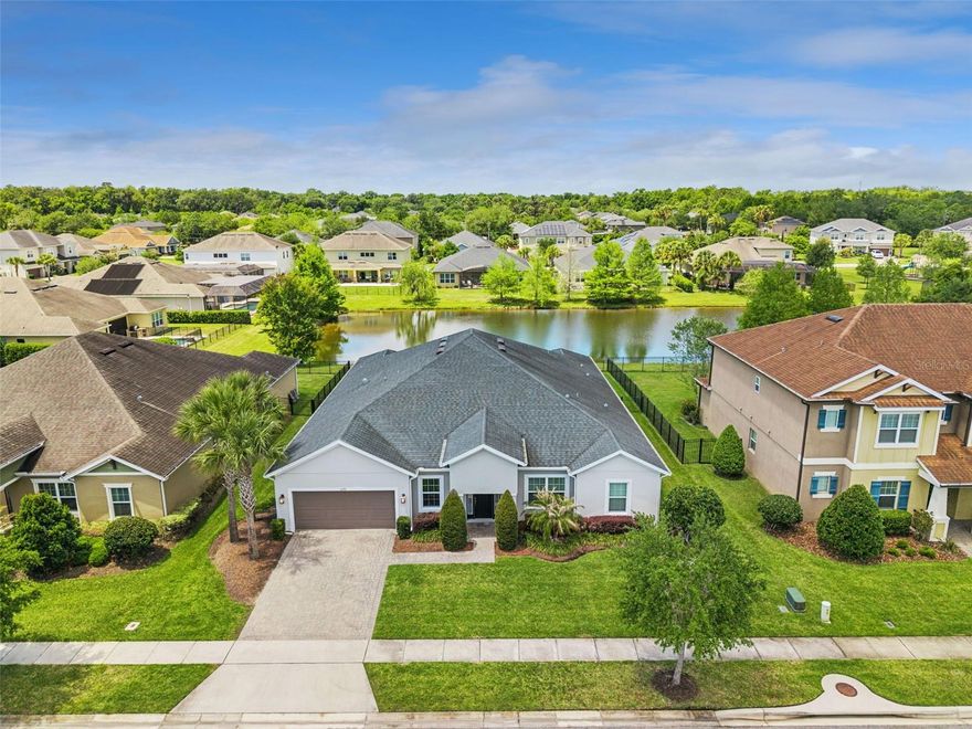 Welcome home!  Located in the gated community of Retreat at Lake Charm, where modern elegance meets comfort and thoughtful design. This impeccably maintained 4-bedroom, 3.5-bath residence offers a bright, open layout with stylish upgrades throughout. From the moment you enter, you’re greeted by a welcoming foyer that leads to a stunning formal dining room featuring a designer accent wall—perfect for hosting memorable gatherings. Just off the entry, a private office/flex room with French doors provides the ideal space for working from home or a quiet retreat.  At the heart of the home is a gourmet kitchen designed to impress, complete with double ovens, upgraded stainless steel appliances, quartz countertops, an incredible amount of counter and cabinet space, a walk-in pantry, and even a dedicated coffee bar. The oversized island opens seamlessly to the spacious living area, all enhanced by abundant natural light that creates a warm and inviting atmosphere.  The split-bedroom floor plan offers optimal privacy, with the luxurious primary suite tucked away from the secondary bedrooms—creating a peaceful retreat with a spa-like ensuite bath and generous closet space. Designed for both relaxation and entertaining, the living area flows effortlessly through triple sliding glass doors to a covered, screened lanai overlooking serene water views. Whether you're enjoying your morning coffee or unwinding at sunset, this outdoor space is truly special.  A standout feature of this home is the versatile bonus room—perfect for a media room, gym, playroom, or guest space to suit your lifestyle.  A 3-car tandem garage offering ample space for vehicles, storage, or hobbies.  Ideally located with easy access to 417 and 434, and just minutes from Oviedo on the Park and Black Hammock, this home is also zoned for top-rated Seminole County schools: Lawton Elementary, Jackson Heights Middle, and Oviedo High.  If you’re looking for a meticulously maintained home that combines style, space, privacy, and stunning water views—this is the one you’ve been waiting for.