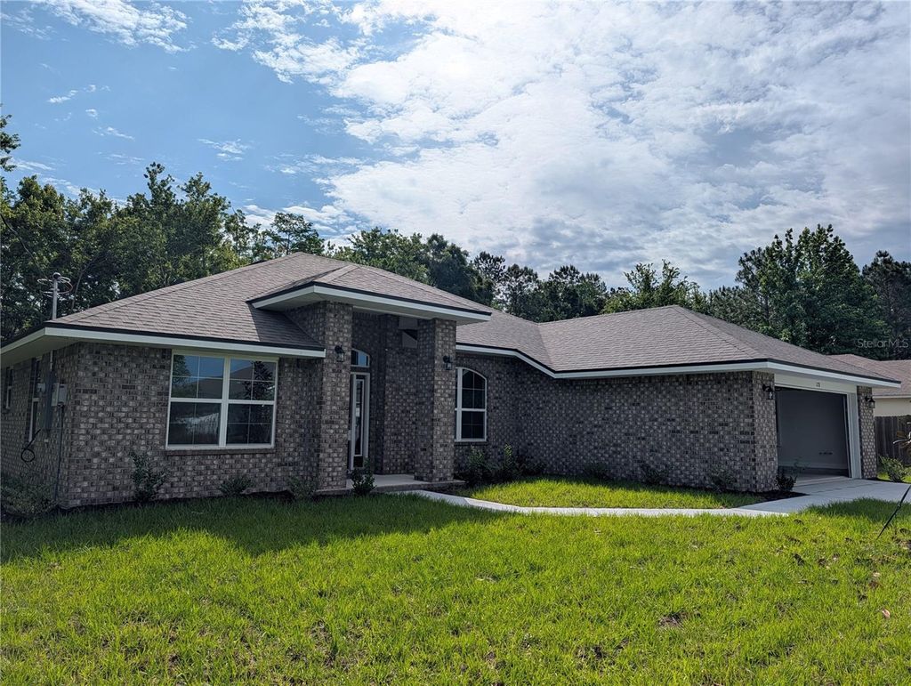 Photo of 128 Bird Of Paradise Drive, Palm Coast, FL 32137 (MLS # O6404093)