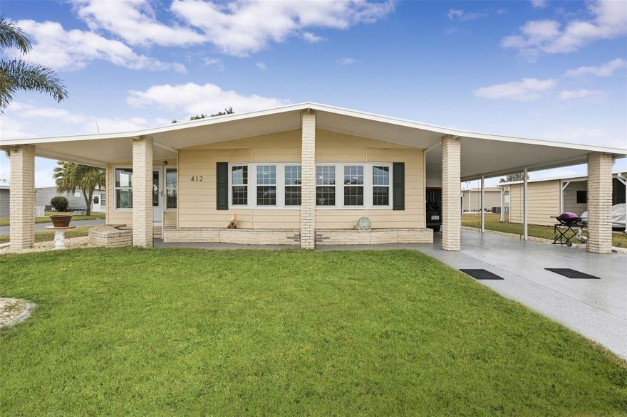 Brick pillars mark the entrance to this well-maintained two-bedroom, two-bath La Casa home. The pillars are secured to the overhang with tiedown straps. A widened, painted driveway leads to a tiled, vinyl-enclosed lanai and an extended utility room with a washer, dryer, deep sink, storage, and a 2020 electric water heater. The entry hall offers a washer and dryer hookup. The kitchen, remodeled in 2025, includes new cabinets, raised counters, a tiled backsplash, appliances, and a pantry. The open floor plan connects the kitchen, dining, and living areas into one spacious space. The bright living room features a vaulted ceiling and a sliding door to the carpeted Florida room, which includes a queen sleeper sofa and access to both the rear patio and the front covered walkway. Additional storage is available with a hall closet and a half pantry. The guest bedroom has two double closets and a sliding door to the Florida room. The guest bath offers a walk-in shower, new vanity, new commode, and a linen closet. The primary bedroom features a vaulted ceiling and two double closets, while the en suite bath includes a new vanity, commode, tiled walk-in shower, and extra cabinets for storage. Additional features include an automatic lawn sprinkler system, new windows (2017), new roof (2018), and A/C (2018). Come and enjoy the La Casa lifestyle in this lovely home located near our Rec Hall, pool and amenities.  La Casa offers the ultimate lifestyle on Florida's Gulf Coast, and is located between Sarasota and Fort Myers with boat access to the Myakka River.  La Casa is a quiet 55+ community of 974 home sites nestled among a variety of native trees.  Spacious common grounds surround our eight lakes. Welcome To the Good Life!  RECREATION, 2 Clubhouses, 2 Heated Pools.  There is no shortage of activities in this community!