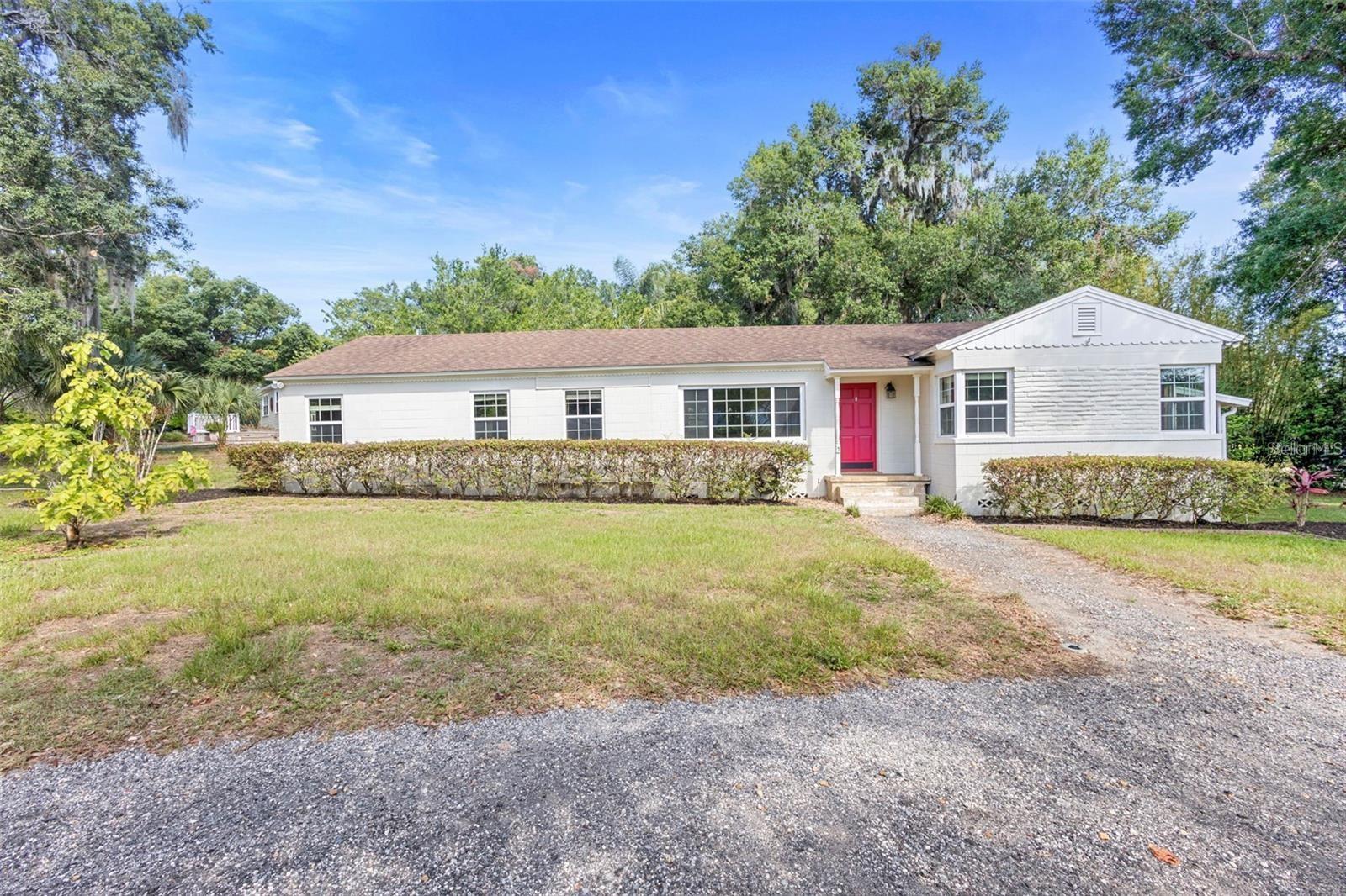 Welcome to historic DeLand, Florida where this 1950’s three bedroom two bath stunner is located. The only thing vintage about this home is the good bones; everything else has been stylishly updated. Inside, you’ll find beautiful ceramic tile and wood floors throughout, fresh paint, crown molding, a large galley kitchen with endless cabinet space, Corian countertops, stainless steel appliances, and a natural gas range. The bathrooms feature updated vanities, tubs, tiled showers, plumbing & light fixtures. The windows throughout the home have been replaced and there is a ton of closet space. The formal living room and dining area are perfect for entertaining and an additional large great room off the kitchen for those large holiday gatherings or embrace your inner HGTV vibe and convert it into a large master suite. The possibilities are endless. The home sits on a spacious .33 acre lot with a fenced in backyard that doubles as your tropical oasis complete with bougainvillea, giant salvias, and a star fruit tree ready to be picked. This gardener’s dream also has a small room off the back of the house perfect for a gardening shed or workshop plus an additional storage shed so your tools don’t have to fight with your holiday decorations for space. There’s so much to do in downtown DeLand which this home sits only two miles from. Enjoy the fantastic shopping, restaurants, breweries and wine bars. You can cheer on the Stetson Hatters at a sporting event or soak in some art and culture at the DeLand Museum of Arts or take in a show at the Athens Theater. DeLand is a short drive to the beaches, Deleon Springs and Blue Springs state parks for the outdoorsy sunbathers, surfers or kayakers and forty minutes from Orlando. Come on! Make your appointment to see this gorgeous home in delightful DeLand!