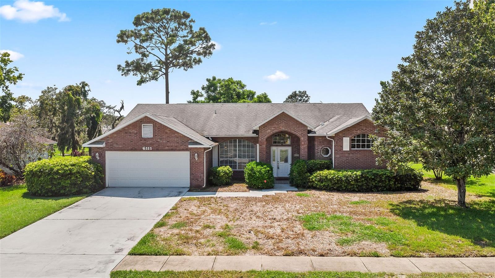 NEW ROOF (soon) This Stunning All-Brick Home in Sun Lake Estates features an Open/Split Floor Plan, Brazilian Hardwood and Tile Floors, Granite Countertops, a Breakfast Bar, Eat-In Kitchen, Separate Dining and Family Rooms, and an All-Glass Tile Florida Room/Lanai with Electric Shades and Mood Lighting. Enjoy Crown Molding Throughout, a Beautiful Landscaped Yard, an Incredible View of Sun Lake with Fountain, Termite Bond, Large 2-Car Garage with Additional Shower, Separate Laundry Room, Lawn Irrigation System, and a Huge Master Suite—offering Exceptional Quality and Comfort Throughout.