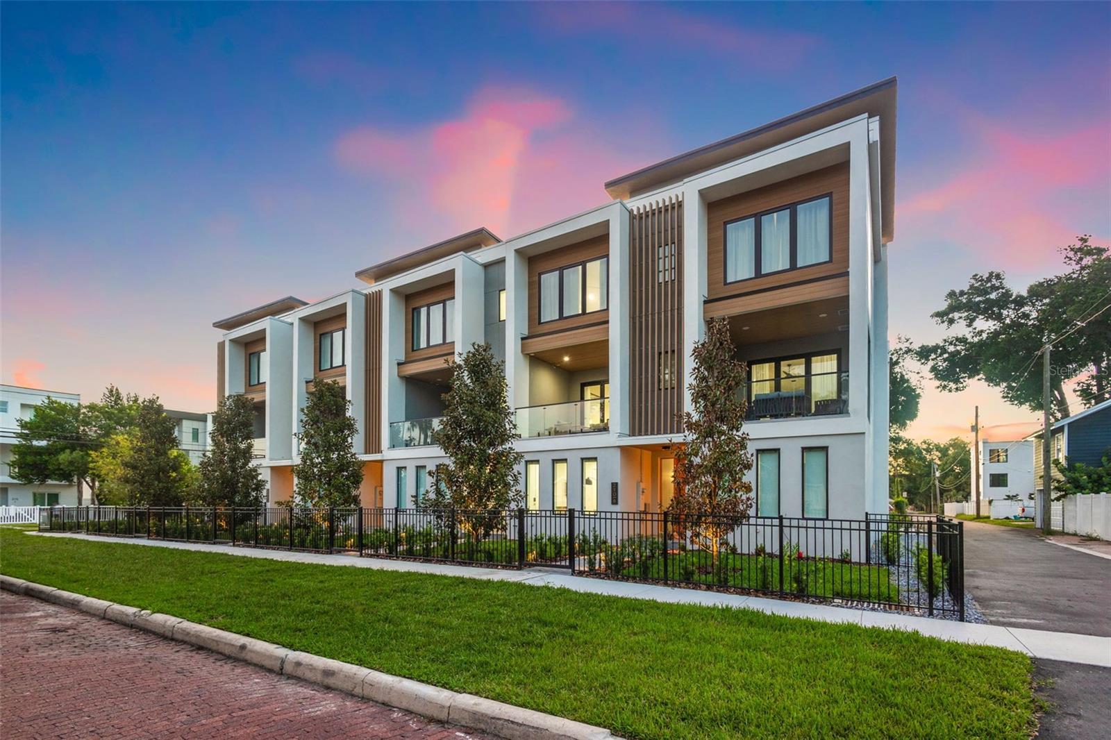 Welcome to Alta! This beautiful development located in the heart of Tampa Heights is perfect for those looking for a modern home in the perfect location! Embodying modern luxury combined with urban design, this development will be sure to please! Featuring 3 floors of living space, consisting of four bedrooms, including a ground floor full bedroom/bathroom with its own independent entrance. As you head to the second floor you will find the main living area and prepare for your eyes to feast on the eye capturing feature wall! The main living floor provides an open concept combination living, dining and kitchen area, making it a perfect space for entertaining and bringing family and friends together. Create culinary masterpieces in this chef's dream kitchen with custom cabinetry, stainless steel appliances, quartz countertops & an over-sized island. Keep it casual and dine at the largest island in Tampa (a crane had to hoist this in place), sit down in your formal dining area, or bring the outdoors in and relax on your private terrace accessed via folding accordion doors. Head upstairs to your serene master oasis complete with a large walk-in closet and spa-like master ensuite custom to your taste and personality. Upstairs also features in-unit laundry, 2 additional bedrooms and 1 additional full bathroom. Additional features include all- block construction, attached 2- car garage, & massive windows streaming in Florida's beautiful light! Walk to all that Tampa Heights has to offer such as Armature Works, Hall on Franklin, Woven Water Brewery, Tampa Riverwalk, Downtown Tampa, & much more! Come live in one of Tampa's hottest neighborhoods!