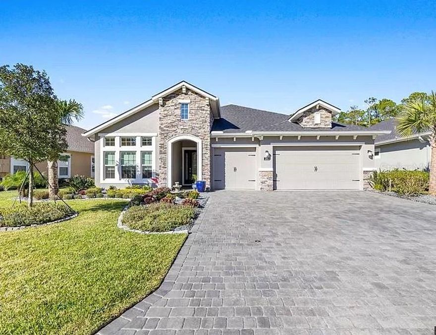 Luxury Estate Home - Ready to move in now! Located on a private cul-de-sac in Plantation Bay, Gated Golf Community built in 2020 with over 2400 living sq. ft. Home greets you with a beautiful paver oversized driveway, 3 car garage and professionally designed landscaping. Sherwin Williams Emerald paint throughout interior, incl. WHITE ceilings, 3 beds, 3 baths, a flex room with many upgrades including the 12x24 tile, Smart Home features, Sensor Lights, Electric Window Coverings, Plantation Shutters, Custom Drapery, Custom European Closet in master, designer kitchen with Quartz and SO MUCH MORE! 12ft sliders lead you to the lake view lanai w/plenty of room for a pool (renderings available). It's plumbed and wired for a summer kitchen, and an exhaust vent is already installed, easily making

this a perfect outdoor oasis! ;Water: City