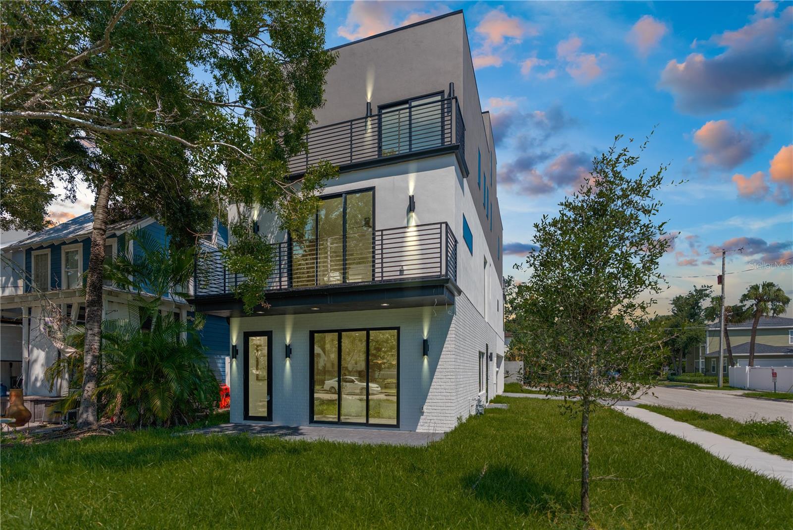 Welcome to 426 S Oregon Avenue—an architectural gem nestled just two blocks from Hyde Park Village. This brand-new, never-lived-in single-family home offers a rare opportunity to lease one of Tampa’s most thoughtfully designed residences. Home is being rented UNFURNISHED.
Spanning four levels, the home opens with a formal living and dining area on the first floor, along with a charming front porch framed by sliding glass doors that create a seamless indoor-outdoor connection. The two-tone chef’s kitchen is outfitted with state-of-the-art appliances, quartz countertops, and designer-selected finishes, anchored by wide-plank engineered wood flooring that runs throughout the home.
Upstairs on the second level, you'll find a massive family room with a gas fireplace and balcony, plus a spacious primary suite with a walk-in closet and spa-style en-suite bath. The second floor also features a full laundry room with washer and dryer included for added convenience.
The third floor hosts two additional bedrooms, each with their own en-suite bathrooms and private balconies—one of which serves as a second primary suite, ideal for guests or multi-generational living.
Crowning the home is a dramatic 1,000-square-foot rooftop deck, split into two wings: one side offers direct views of the downtown Tampa skyline, while the other overlooks Hyde Park Village. Whether you’re entertaining under the stars or enjoying a quiet morning coffee, the rooftop becomes your private urban sanctuary.
Additional features include custom tilework in every bathroom, high ceilings throughout, and unbeatable walkability to South Tampa’s best restaurants, boutiques, and cafes.