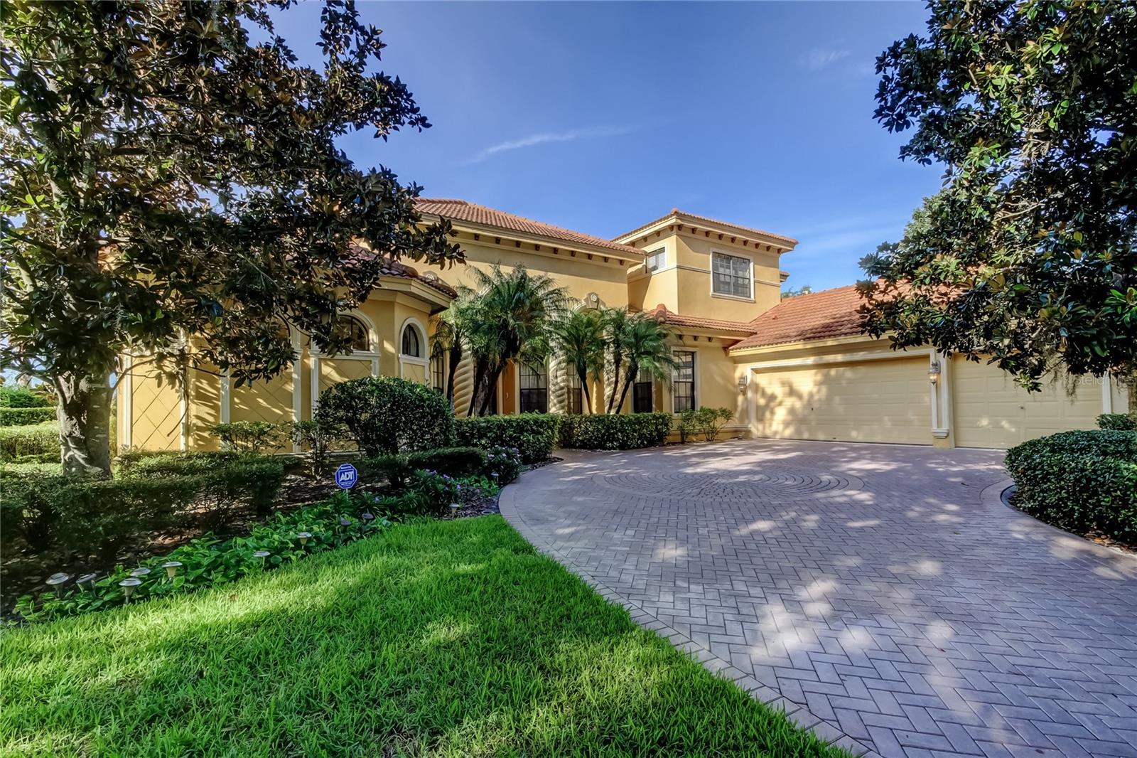 RARE WATERFRONT LUXURY OPPORTUNITY in Champions Club! Welcome to this CUSTOM-BUILT Masterpiece by Costanza Homes, offered by the ORIGINAL OWNER and Located in the HIGHLY DESIRABLE, GATED Enclave of Mirasol within Champions Club. Perfectly positioned on a PREMIUM WATERFRONT LOT with PANORAMIC LAKE AND GOLF COURSE VIEWS, this Stunning Residence backs to the Renowned Fox Hollow Golf Course, a Robert Trent Jones Sr. Design. Boasting Over 4,000 Square Feet of Heated Living Space, this Elegant Home offers 5 Bedrooms, 4.5 Bathrooms, an Oversized 3-Car Side-Load Garage, and an Expansive Bonus Room—ideal for a Home Theater, Game Room, or Gym. Step through Double Leaded Glass Entry Doors into a Grand Foyer with Soaring Volume Ceilings and admire the Luxurious Polished Travertine Flooring that Flows Seamlessly Throughout the Main Living Areas. The Formal Living and Dining Rooms impress with Double Tray Ceilings, Crown Molding, and a Gas Fireplace that adds Warmth and Charm. The Heart of the Home is a Chef’s Dream Kitchen featuring rich Wood Cabinetry, Granite Countertops, Tile Backsplash, Upgraded Stainless Steel Appliances, and a 6-Burner Gas Range with Hood. A Large Prep Island with Sink offers both Function and Style, all overlooking a Spacious Family Room with Built-in Entertainment Center. Retreat to the sprawling Owner’s Suite with space for a Sitting Area, Custom Walk-in Closet, and a Luxurious En-Suite Bath complete with Dual Vanities, an Oversized Soaking Tub, and a Walk-in Shower with Dual Showerheads. ENJOY the BEST of Florida Living on the Extended Pavered Lanai with Birdcaged Sparkling POOL and SPILLOVER SPA, Custom OUTDOOR FIREPLACE, and OUTDOOR KITCHEN with Stainless Gas Grill—Perfect for entertaining Guests while taking in BREATHTAKING LAKE AND GOLF COURSE VIEWS!! All Bedrooms are conveniently Located on the Main Floor, except for a Private Guest Suite with Full Bath and Bonus Room Upstairs. Additional features include: Laundry room with Built-in Cabinets and Utility Sink (Washer & Dryer included), Ceiling Fans throughout, Designer Custom Window Treatments. 2 NEW A/C SYSTEMS (2022) and NEW TANKLESS GAS HOT WATER HEATER (2022). Immediate Occupancy available, Champions Club offers World-Class Amenities, including a Private Clubhouse with Gathering Room, Heated RESORT-STYLE POOL AND SPA, Fitness Center, Massage Room, Outdoor Grill & Fireplace, Lighted Tennis and Basketball Courts, and More! Located close to Top-Rated Schools, Trinity Hospital, the YMCA, miles of Bike Trails, Shopping, Dining, and just a short drive to Tampa International Airport and Florida’s Famous Gulf Coast BEACHES. Don’t miss this Incredible Opportunity to Live in one of Trinity’s Most Exclusive Communities. PARADISE AWAITS—Your Escape is just Outside Your Back Door!