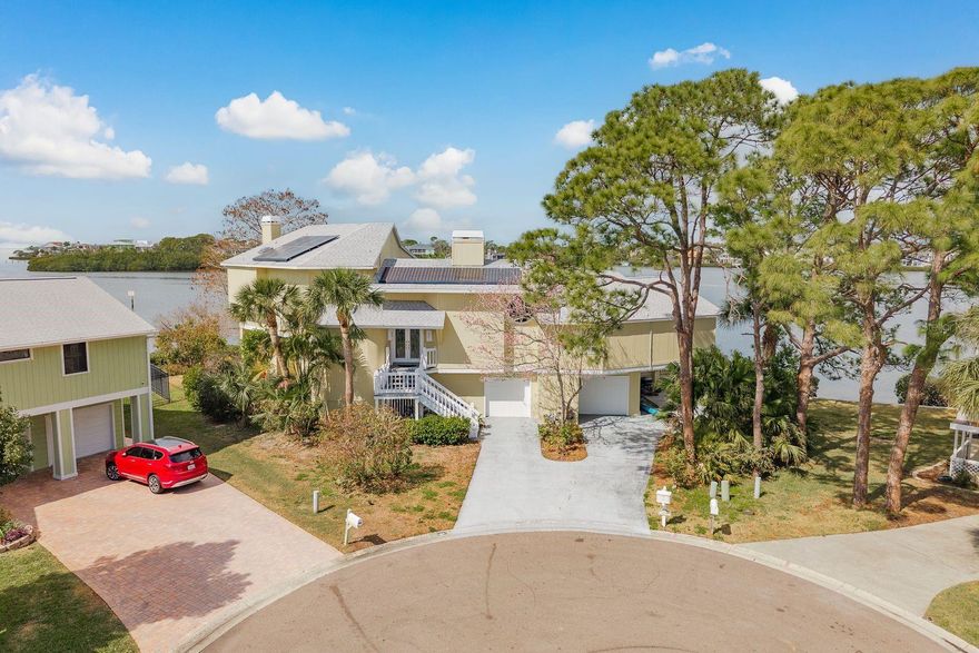 Welcome to 600 Soundview Drive, the ultimate boatable waterfront retreat offering unparalleled views of Southerland Bayou at the mouth of the Intracoastal Waterway. Perfectly positioned in the highly sought-after Ozona community, this exceptional residence rests on a quiet cul-de-sac, providing both privacy and breathtaking panoramic water vistas. This stunning Key West–style home makes an unforgettable first impression with its charming white and yellow façade and eco-friendly solar power. Ascend to the elevated main level where endless water views immediately captivate. The expansive open-concept living area features soaring two-story ceilings and a cozy wood-burning fireplace. The rear of the home offers 180-degree water views and opens onto a wraparound covered. Below, enjoy a sparkling pool and lanai and private dock and covered boat lift. With deep, boatable water, this property is truly a boater’s paradise. Back inside, the main level is designed for entertaining. A spacious bar area flows into the oversized kitchen, complete with granite countertops, stainless steel appliances, custom wood cabinetry with decorative trim, and a breakfast bar overlooking the breathtaking views. Adjacent is a grand formal dining room featuring intricate ceiling detailing and sweeping water vistas. An additional office/bedroom/in-law suite includes built-in bookshelves and an attached half bath with potential to convert to a full bath. A closet pantry, separate laundry room with garage access, and an electric dumbwaiter add convenience and functionality. On the opposite wing, two generously sized guest bedrooms offer sliding door access to the lanai and share a Jack-and-Jill bathroom with dual vanities and granite countertops. An additional guest bath completes the level.
Up the grand open staircase, discover the luxurious primary retreat. A versatile bonus room off the landing ideal for an office, nursery, or additional closet precedes the spacious primary suite with soaring wood ceilings. Additional features include a hobby room or walk-in closet and a beautifully appointed en-suite bath with an oversized soaking tub, seamless glass walk-in shower, double vanities, private water closet, and a custom walk-in closet with built-in organization. A charming sitting room with a gas fireplace and vaulted ceilings adds warmth and character. Take in spectacular water views through custom plantation shutters or step onto your private covered balcony for morning coffee and coastal breezes. The ground level offers a fully equipped in-law suite with a full pool-access bathroom, living room, kitchenette with granite counters, and an additional enclosed flex room recently refurbished ideal for guests or multi-generational living. Two spacious garages, a workshop, and abundant storage complete the space. Notable upgrades include three HVAC systems (2017, 2018, 2020), Roof 2018, a monitored alarm system, two boat docks, and solar power. Situated in a beautifully maintained, HOA-free upscale neighborhood, this home is just minutes from charming downtown Palm Harbor and Crystal Beach, with endless dining, shopping, and award-winning beaches nearby. Tampa International Airport is only a 30-minute drive, along with excellent medical facilities and top-rated schools.
This rare waterfront gem offers luxury living, privacy, and direct access to Florida’s premier boating water. Its an extraordinary opportunity to live the ultimate coastal lifestyle.
