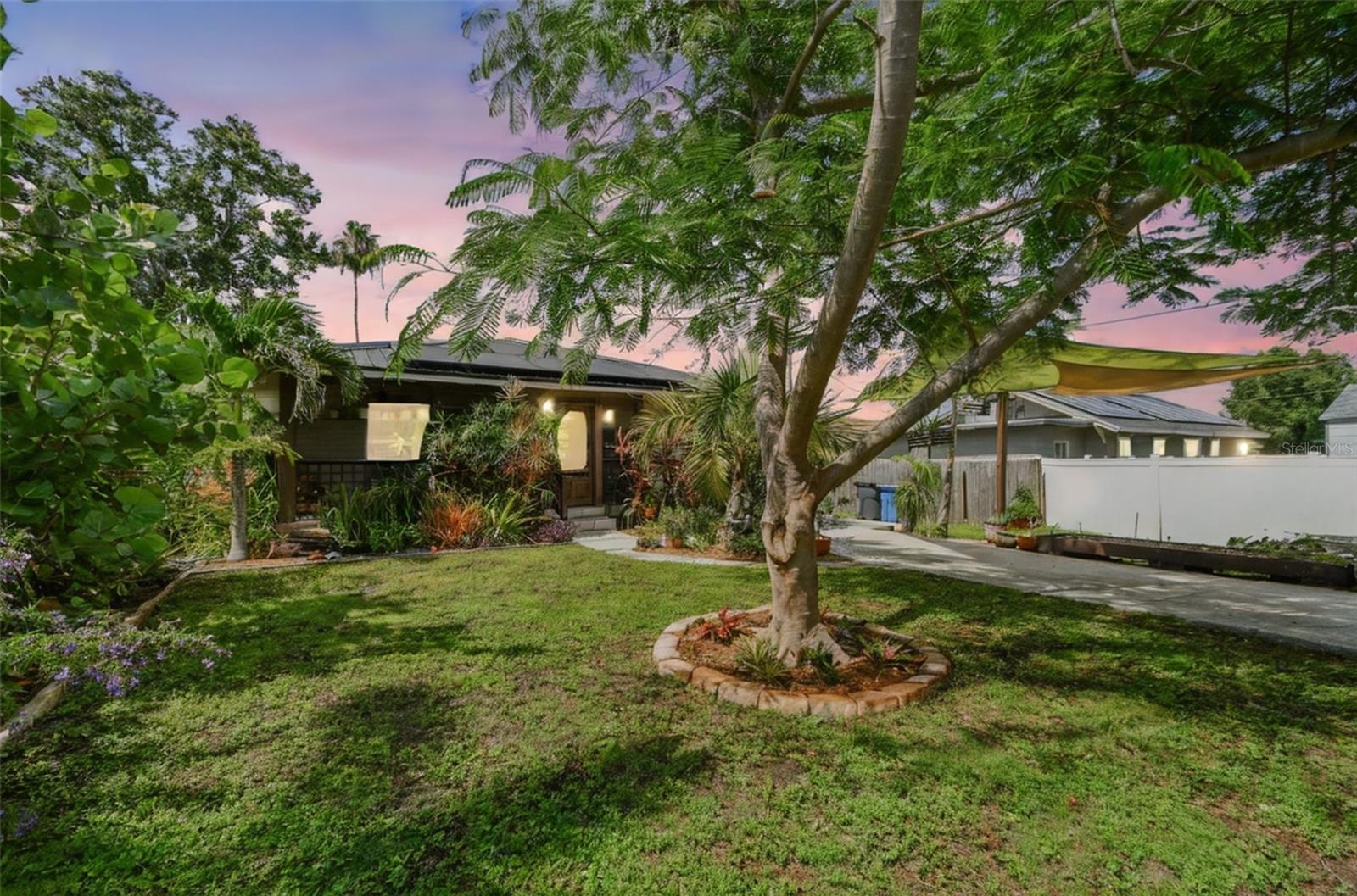 Well-maintained 3-bedroom, 1-bath home in North St. Pete featuring a 2022 metal roof, fresh interior paint, and solar panels for low electric bills. Enjoy great natural light throughout, with tile flooring in the living areas and kitchen, and updated vinyl plank in the bedrooms. The kitchen offers ample cabinetry and newer appliances, and the recently updated bathroom includes dual sinks and a full tub with shower. Located on a quiet street with a fully fenced backyard, inside laundry, and a covered front porch. Convenient to I-275, downtown St. Pete, and local shopping—this home blends comfort, efficiency, and peace of mind.