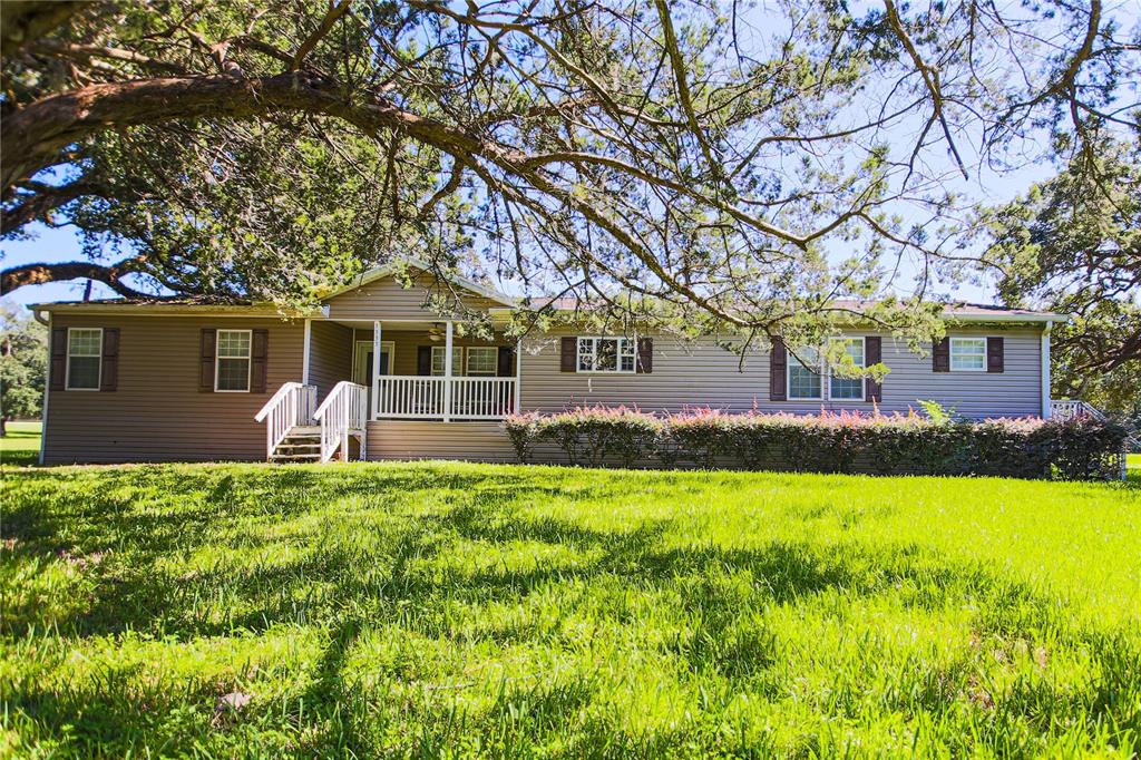 Location! Location! Update. This property has adjoining parcel with home, making total acreage 20.48. This home sits on the front of the property.This mini farm is just minutes from World Equestrain Center. Front of property has MH. Back of property has a 10 stall metal barn and a bunk house. Plenty of room for your horses to run free and beautiful spread for you to build your new home!