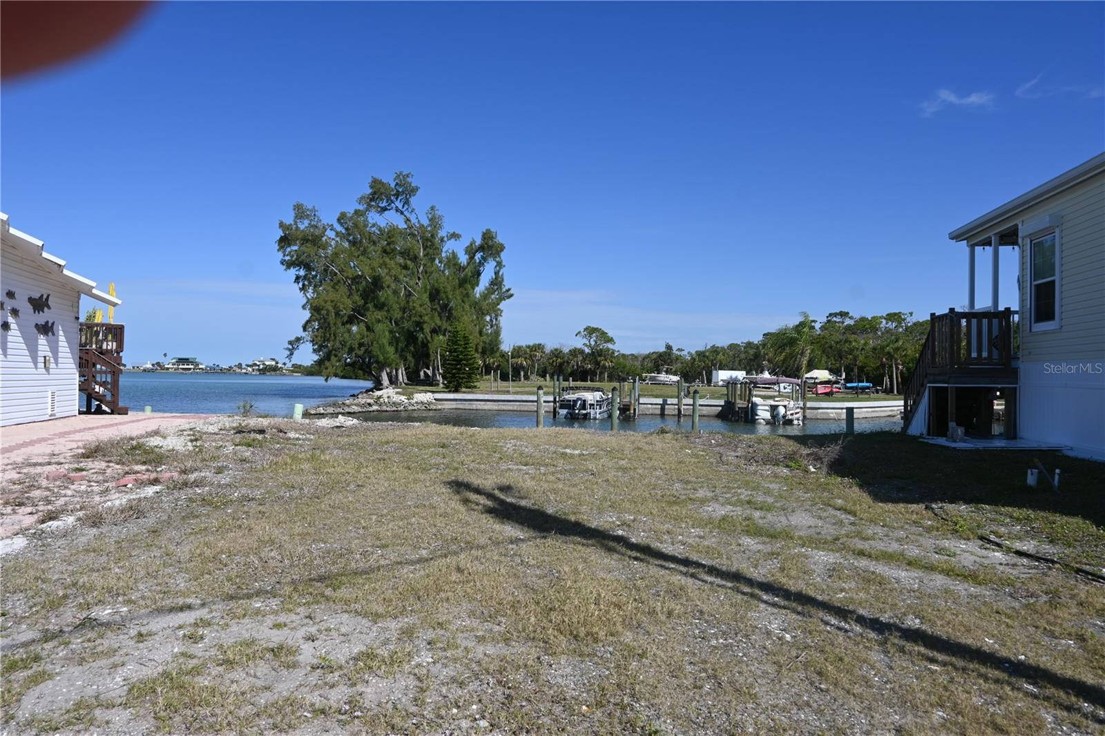 Attention Boaters and Fisherman!!! Here is your chance to be in an Incredible Location in the gated 10 acre Waterfront Community of Park Pointe Mobile Home Village. This Waterfront Lot has beautiful views of the Intercostal Waterway with direct access to Lemon Bay and Stump Pass from the Park’s private marina and boat ramp. The lot has it's own private boat slip. Slips for boats up to 24’ long are also available in the marina for $40/month, which includes off season outdoor boat storage. Stump Pass Marina and the Lighthouse Grill are located next to the Park. Community amenities include an on site office manager, clubhouse, heated pool, spa, on site laundry, gated entry, boat storage lot, community marina and boat ramp, fish cleaning table, and a picnic and kayak launch area on the water. Park Pointe is a 54 unit co-op in which you own 1 share of stock valued at 1/54 of the market value of the Park’s assets. A rotating Board of Directors elected from the stockholders manages the Park and keeps monthly fees as low as possible. Don’t miss out on this opportunity to put your Mobile Home on this beautiful lot and start living the best of the Florida lifestyle. Close to world famous Tarpon fishing on Boca Grande, beaches, shopping, dining and Tampa Bay Rays and Atlanta Braves spring training facilities. Imagine the possibilities!!