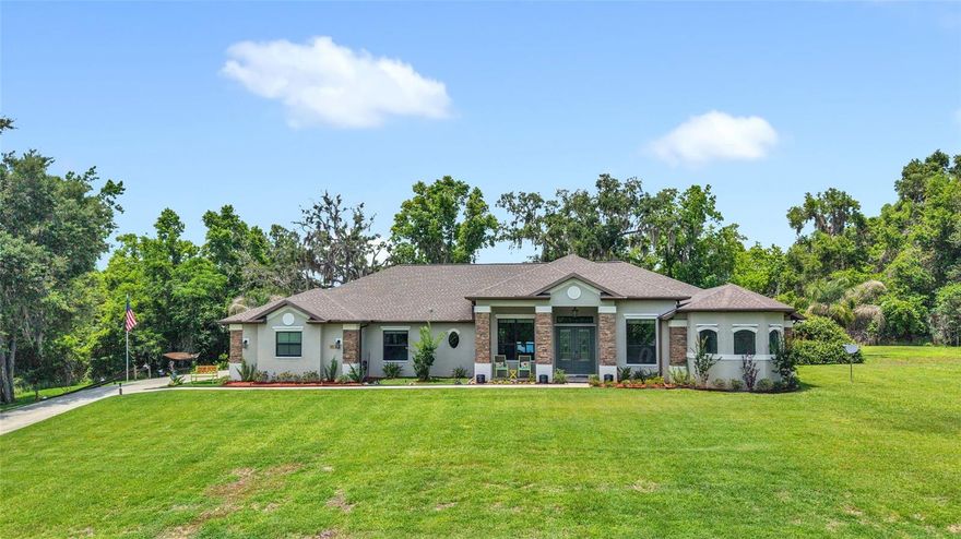 Experience elevated living in this exceptional custom-built luxury residence, completed in 2019 and thoughtfully designed with comfort, elegance, and modern convenience in mind. Situated on a large private lot, this stunning 4-bedroom, 3 full bath home offers the perfect blend of upscale finishes, smart home innovation, and versatile living space. Including a private attached in-law suite with its own separate entrance, ideal for multigenerational living, guests, or potential rental income. From the moment you enter, you'll be captivated by the expansive open-concept layout, soaring tray ceilings, and impressive 8-foot solid-core doors throughout, creating a grand yet welcoming atmosphere. The home is loaded with premium upgrades and intelligent features, including phone-controlled lighting, WiFi-enabled 3-car garage doors, a fully integrated smart home system, and a state-of-the-art 4K Bose surround sound system that delivers an immersive entertainment experience. Designed for both luxury and peace of mind, this home also includes hurricane shutters, a whole-house pest management system, security cameras surrounding the property, and a remote-start whole-house generator for added security and convenience year-round. Step outside to your own private backyard retreat where indoor and outdoor living seamlessly come together. The oversized screened lanai provides the perfect space for relaxing or entertaining, complete with a hot tub, outdoor wet bar, charming gazebo, and beautifully maintained garden areas, all overlooking the expansive private yard with plenty of room to enjoy. Every detail of this remarkable property has been carefully curated to provide a lifestyle of comfort, sophistication, and functionality. This is more than just a home, it's a private luxury sanctuary built for modern living.