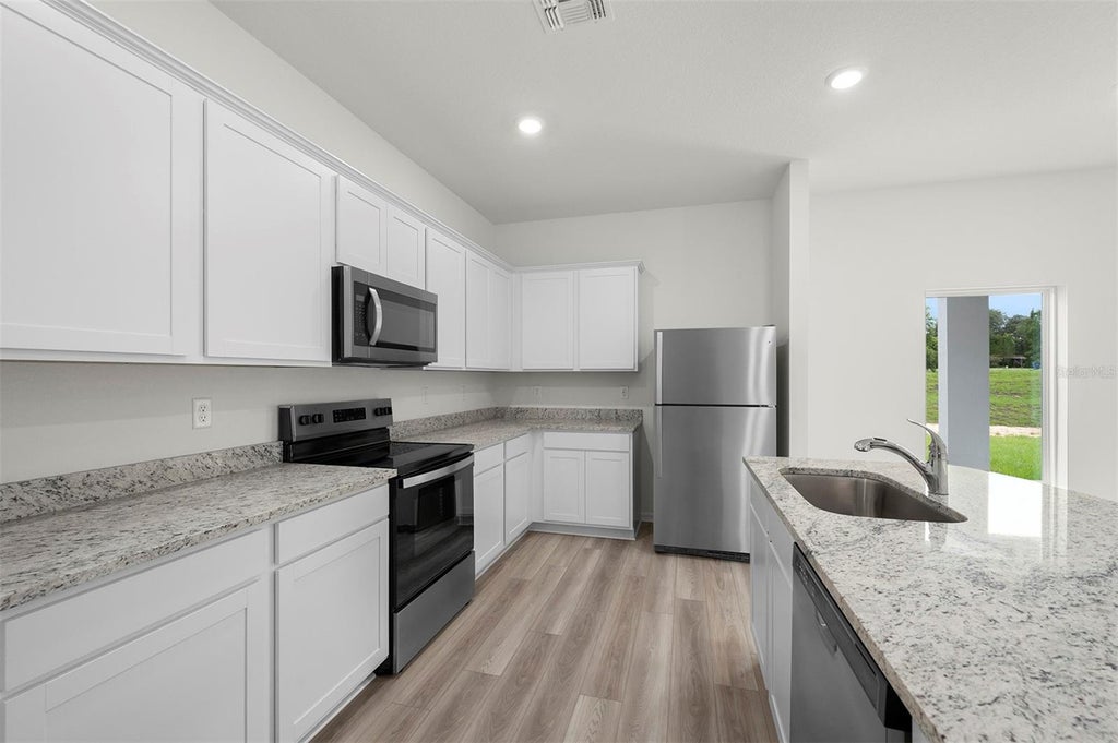 Photo of 13226 Tula Loop, Astatula, FL 34705 (MLS # TB8550954)