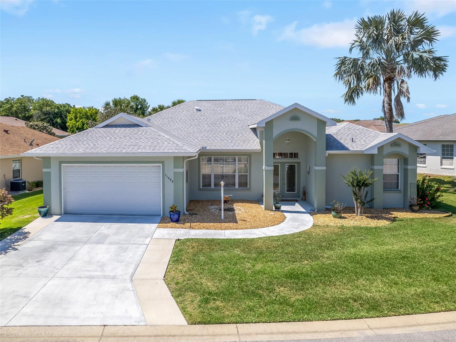 Stonecrest is a 55+ gated golf course community with all the amenities and 4 pools (one indoor), and just a Bridge Away By Golf Cart To The Villages! Come see the Stunning Concrete Block and Stucco 3/2 Boca Grande model with a 2 Car Garage, and Tremendous curb appeal featuring Low Maintenance Professional Landscaping, and a Covered Front Entrance with Elegant Leaded Glass French Door access. As you enter into the foyer you are greeted by Soaring 10 ft ceilings Throughout, Designer Light fixtures, and a Spacious Open, and Split Floor plan, just perfect for Entertaining Family and Friends! The Kitchen boast over 30K in Upgrades showcasing Granite countertops, Maple stained 42" cabinetry with Pull-Outs & LED lighting, Stainless appliances, Built In Double Wall Ovens, Cook Top, Center Island with additional storage & Sitting area, Pantry closet with Pull-Outs, and an Eat in Area! The kitchen flows seamlessly to the Huge Family Room, which offers sliding door access to the Enclosed Lanai! The Split Floor Plan affords maximum Privacy for both the owners and their guests, as the Primary Suite is located at the opposite side of the home from the guest bedrooms and guest bathroom. The Luxurious Primary Suite boasts a Private Entry to the Lanai, New Luxury Vinyl Plank flooring, 2 Walk in Closets and the Remodeled En Suite Bathroom, featuring 2 Vanities, Tub, Private Water Closet, and a Tiled Walk in Shower. The two additional bedrooms feature nice size built in closets and, provide plenty of convenience, and space for your guests! The 31 x 13 Huge Enclosed Lanai with Wood Look Tile flooring, and 2 ceiling fans, creates a Fantastic Additional Living Space, perfect for enjoying Evening Dining, Beautiful Florida Sunsets, and Tropical breezes! You will love having plenty of room for storage in the nice size 2 Car Garage. Roof 2018, Hot Water Heater 2020, HVAC 2015. Stonecrest is a 55+ gated golf course community with all the amenities, pools, pickleball courts, softball, 18 hole championship golf course, Broad Stripes Golf & Social Club and over 80 different clubs to join! It is a community with Private Roads and 24 Hour Security! As a private gated golf course community, you can expect a high level of privacy and security. Overall, this home offers a combination of Exceptional Living Space, Luxurious Features, a Desirable Location, and a Secure Community Setting. A WONDERFUL LIFESTYLE AWAITS YOU IN STONECREST!