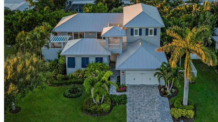 Exuding coastal charm, this spacious four bedroom, three full baths, and two half baths Brista Homes masterpiece is a true tropical find just 500 feet from the beach. Behind its inviting façade lies a private courtyard oasis with a resort-style heated pool, sun shelf, and pergola with rain-shower waterfall—an everyday escape that feels like vacation. The first-floor master has an en suite bath with marble countertops, dual sinks, doorless shower and a soaker tub. Rich details such as wainscoting, shiplap accents, wide plank oak floors, beamed tray ceilings, crown moldings, and 12” baseboards create a timeless backdrop. Modern comforts abound with plantation shutters, Lutron lighting and shades, impact windows and doors, a security system, metal roof, and three zone AC. The kitchen boasts a large island, Sub Zero refrigerator, Thermador appliances and an adjoining butler’s pantry. A private office and generous living spaces add convenience. Guests will love the second-floor guest rooms and terrace overlooking the courtyard or the separate casita, complete with a bedroom, full en suite bath, and closet. A beach access point is just steps away. Ideally positioned mid-key, the location offers easy access to both north and south Longboat amenities—all with the added benefit of no HOA fees. The gated yard makes it ideal for pets, and the home is offered move-in ready, with designer furnishings available separately. This property embodies the effortless elegance of Longboat Key living.
