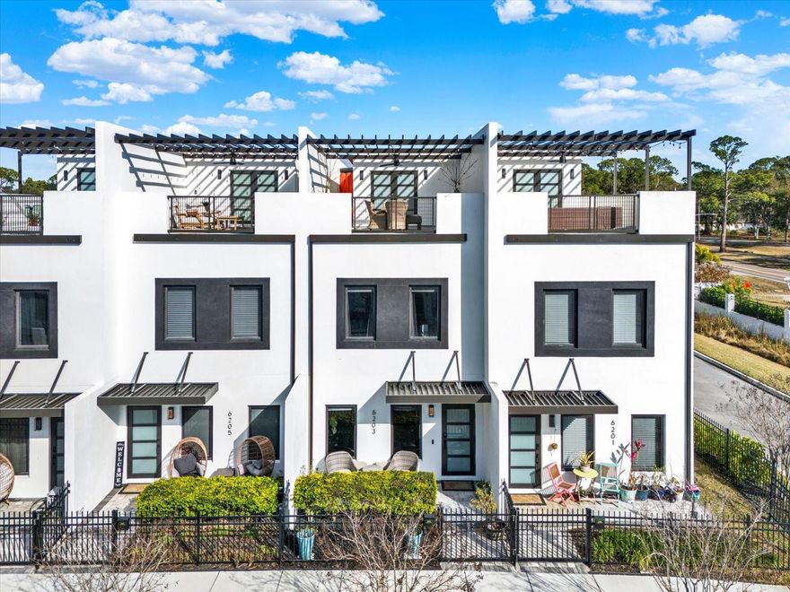 Experience luxury, exceptional functionality and plenty of space with 3 bedrooms, 2 full bathrooms, 2 half bathrooms, a bonus room plus a loft in this 2024 CONSTRUCTED townhome. This townhome offers over $40,000 in premium upgrades compared to new construction in the area. All windows and doors are HURRICANE-IMPACT RATED, offering enhanced storm protection, energy efficiency, and long-term value. Thoughtfully designed and move-in ready, this residence blends striking architectural details with resort-style outdoor living. Inside, a dramatic floating staircase anchors the open-concept layout, complemented by luxury vinyl plank flooring throughout for a seamless, low-maintenance finish. The gourmet, open kitchen features quartz countertops, upgraded LG appliances, including an induction range and generous storage. An EV CHARGER has also been installed in the garage. One of the home’s most impressive features is the expansive ROOFTOP TERRACE, complete with a covered patio and fully equipped outdoor kitchen — an ideal setting for year-round entertaining and enjoying Florida’s beautiful weather. Located in an GATED COMMUNITY, that allows SHORT TERM RENTAL and the bank does not require flood insurance (Flood Zone X).  You will live near top rated beaches, dining, shopping, and major roadways and bridges that make it easy to travel to downtown St. Pete or into Tampa. FURNITURE AND DECOR NEGOTIABLE.