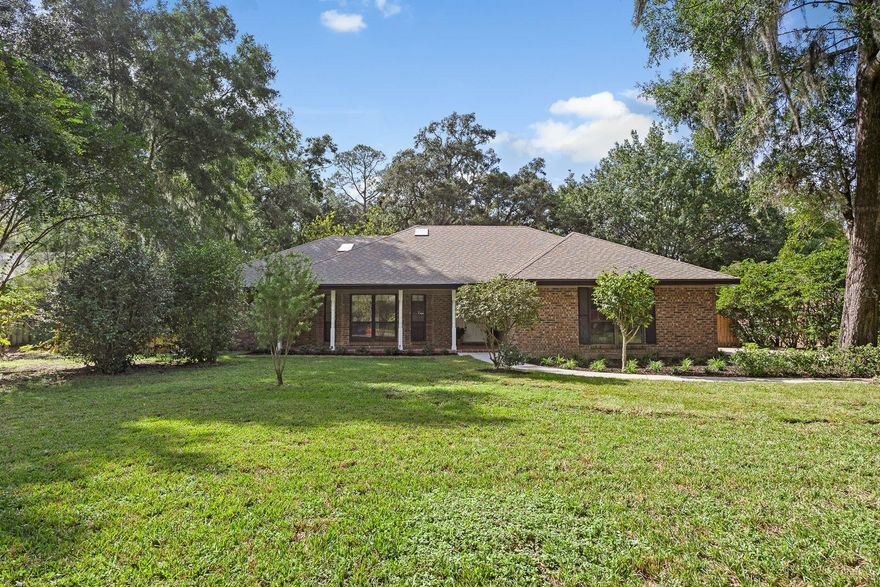 Beautifully maintained home located in the highly sought-after community of Coventry. This true Arthur Rutenberg built pool home offers timeless craftsmanship and thoughtful design. Featuring a desirable 3-way split floor plan with 4 bedrooms and 3 bathrooms, the home includes both formal living and dining rooms, blending open-concept living with classic charm. The beautifully remodeled kitchen (2020) is the heart of the home, showcasing rich wood cabinetry, granite countertops, a stylish tile backsplash, and updated appliances. It flows seamlessly into the breakfast nook and spacious great room, where a stunning floor-to-ceiling brick fireplace serves as the focal point. High ceilings and abundant natural light create an inviting, airy feel throughout. The layout offers ideal privacy and flexibility for every lifestyle. The large primary suite sits on its own side of the home and features French doors leading to the covered patio, a spacious bathroom with an expansive double-sink vanity, abundant storage, and a generous walk-in closet. The opposite side of the home includes, one wing featuring a private bedroom tucked away in its own hallway with a large closet and a full bathroom with a walk-in shower, perfect for guests or multi-generational living. This bathroom also doubles as the convenient pool bath. Then there is an additional wing, which includes two oversized bedrooms with ample closet space, connected by a shared hallway and bathroom. Off the laundry room, you’ll find a spacious bonus room that offers incredible versatility, perfect for extra storage, or easily transformed into a home office, playroom, mudroom, or workout space to suit your needs. The flow of the home is perfect for both formal and casual entertaining. French doors off the kitchen open to a large covered patio, ideal for hosting gatherings, relaxing by the oversized pool, or grilling while enjoying peaceful views of the vacant lot that sits behind the home and its mature trees. The expansive backyard offers endless possibilities for outdoor living or play. Recent updates include removing the false/dropped down ceilings in all bathrooms and freshly painted  with new recessed lighting and a new vanity light in the primary suite. The exterior has also been refreshed with new landscaping, a repainted pool deck, and a widened front walkway leading to a charming covered porch overlooking the spacious front yard. The extended driveway provides plenty of parking in addition to a 2-car garage. Major improvements include full home repiping (2018), ensuring peace of mind for years to come. Conveniently located near tons of shops, restaurants, schools, parks, Santa Fe University, Shands Hospital, University of Florida, and North Florida hospital. This home perfectly combines comfort, style, and functionality in one of Gainesville’s most desirable neighborhoods.