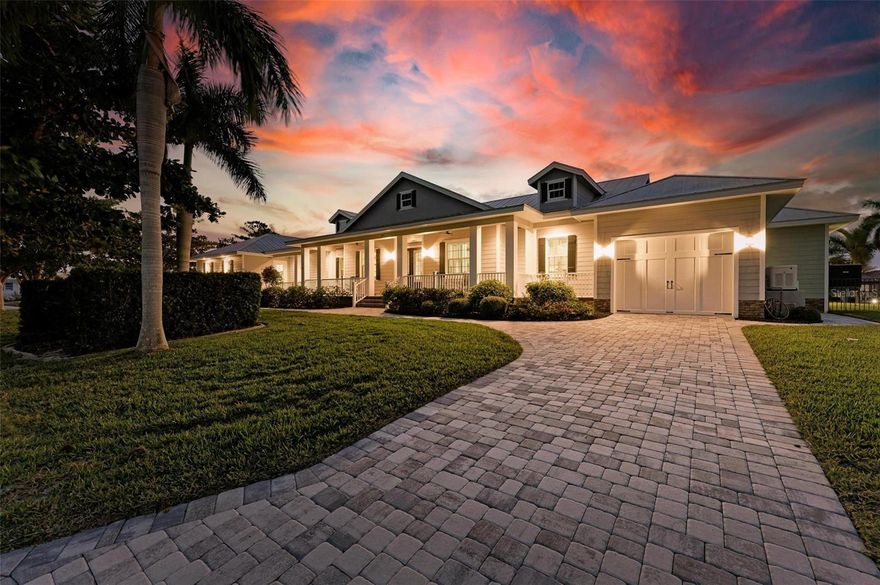 WATERFRONT LUXURY FOUND in this 2016 Built Custom 4-bedroom, 3.5-bathroom, 4 Car-Garage home with pool/spa, IMPACT WINDOWS & Sliders, a WHOLE HOME GENERATOR, and an In-Law Suite on a DOUBLE LOT totaling over 1/2 acre with NEW DOCK & 13,500lb lift moments from Charlotte Harbor with NO BRIDGES awaits new owners! On a corner lot with underground utilities, find a thoughtful design with amazing curb appeal including upgraded landscaping, and split garages/driveways with a large covered front porch reminiscent of Southern homes.  Inside the foyer, enjoy 14' ceilings, engineered hardwood floors, 8' doors, and incredible wood-working throughout including tongue and groove ceilings, with a formal living room and dining room at the entrance with wainscoting, open to the large great room with vaulted ceilings with exposed wooden beams connecting all the way through this space and into the chef's kitchen, all overlooking the pool area and waterway beyond via pocket sliding glass doors. The kitchen is a DREAM with a breakfast bar, a separate island with second prep sink, a large 6 burner Miele gas stove with commercial hood, Miele microwave/built-in oven, and a new Samsung refrigerator. This area also has a butler's pantry with bar with wine fridge, a walk-in pantry, and connects back to the dining room.  Also, off the kitchen, a dinette area overlooks the pool, and a dedicated guest/pool bath is ideally situated here. Through the barn door off the kitchen, enter the In-Law Suite with separate hallway with storage, a 1 car garage with 220 electric car hook-up and generator equipment, a kitchenette, a large bedroom with a spacious walk-in closet and en-suite bathroom with shower. This area also has private access to the pool through pocket sliding glass doors overlooking the water.  On the other side of the home, off the great room, find the spacious primary suite with coffered ceilings with wood detail and a large sitting area, direct lanai access via sliding glass doors, a HUGE walk-in closet, and an en-suite bath with dual vanities and custom cabinetry, a separate tub, a walk-in shower with 4 shower heads and a stone bench, and a private water closet. Farther down the hall find 2 guest bedrooms with a Jack/Jill Bathroom with dual sinks and a tub/shower combo, a study with barn doors with a built-in Murphy bed and bookshelves, and a large laundry room with custom cabinetry a sink, and connection to the oversized and extra deep 3 car garage with epoxy floor.  Outside on the lanai, enjoy a private oasis with an outdoor kitchen with propane grill/burner/commercial hood and bar, all overlooking the oversized heated pool and spa with extra space to relax both inside the screen enclosure and outside on the patio in the fenced backyard.  Farther at the water's edge, a new 30' concrete dock and lift await with 99' of concrete seawall, maintained by the city. Keep your boat in the backyard less than 1/2 mile straight to Charlotte Harbor! There are SO MANY UPGRADES so be sure to ask for the full Features Sheet! This home is located nearby to downtown Punta Gorda, Fishermen's Village, near great golf, shopping, restaurants, and just across the harbor from Sunseeker Resort. Schedule your showing today!