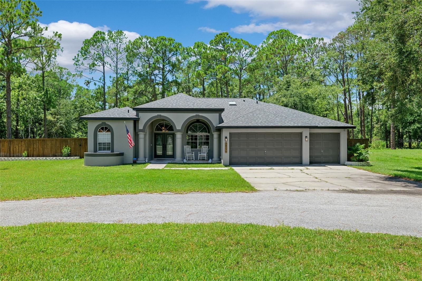 Welcome home to your slice of Florida Country Living just minutes from in-town amenities. NEW ROOF 2024, NEW AC 2023, NEW WHOLE HOUSE WATER SYSTEM AND WATER HEATER 2024. Exceptional properties like this are very few and far between – blending the benefits of large parcel, 4 bed 3 bath, NO HOA, NO CDD, country style living with the proximity to shopping, schools, highway access and everything the modern life requires! Situated on nearly 5 acres of exquisite Florida land – the possibilities are endless! Meticulously renovated from top to bottom – this once neglected home has been through every possible improvement; flooring, roof, septic, kitchen and baths, edited floor plan to include a blended butler/homesteader pantry and laundry; not to mention upscale cosmetics like fabulous landscaping, timeless coffered ceiling throughout the open living spaces, rejuvenated yard which is now fully fenced for privacy without damaging the serene woodland views from your covered patio and shimmering pool. This property will make you the envy of the family – with 3 full guest rooms, and 2 separate guest baths, entertaining and hosting has never been easier. The spacious circular drive provides ample parking, plus the oversized 3 car garage is just the tip of the vehicle and workshop iceberg! This property also has an auxillary drive to the rear of the home for RV/toy parking in front of ANOTHER full 3 bay workshop measuring 24X34. Words cannot express the peace that envelopes this property through and through – watch deer and Sand Hill Cranes from the comfort of your lanai. Less than 5 minutes to The Grove and KRATE; you’re barely a car ride away from anything you could possibly need; World Market, Best Buy, BEALLS, ULTA Beauty, Planet Fitness, Michaels Crafts, TJ MAXX, Old Navy, 5Below, PetsMart and Dicks Sporting Goods! Don’t miss this fantastic property – call today for a private viewing.