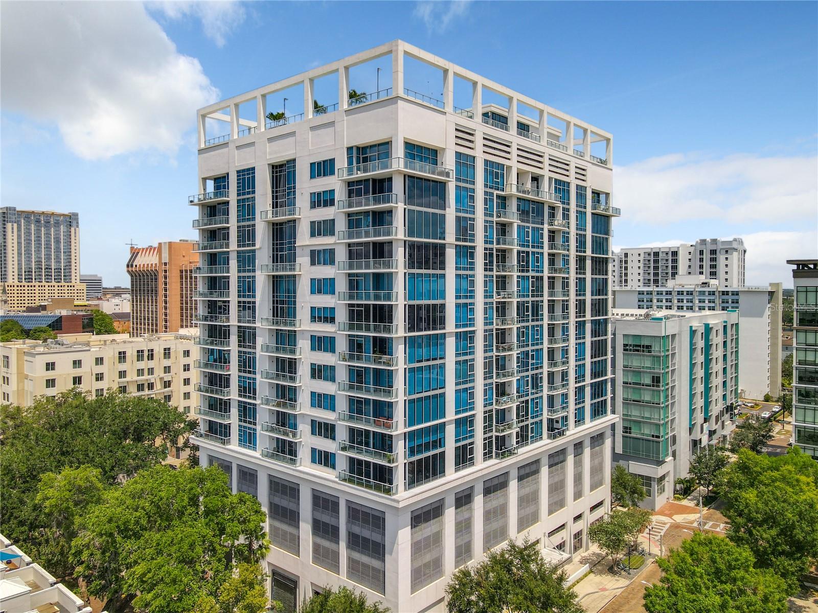 Welcome to Unit 607 at Star Tower, where sleek modern design meets effortless city living. This 2-bedroom, 2-bath luxury condo with a versatile flex space—ideal as a dining room, den, or home office—offers the perfect blend of style and functionality in one of Orlando’s most walkable and vibrant neighborhoods.
Located in the desirable South Eola area of the Thornton Park District, Star Tower is a boutique high-rise where luxury and artistic influence converge. Step outside and immerse yourself in a dynamic community filled with neighborhood cafés, art galleries, local boutiques, and tree-lined streets. Enjoy weekends at Lake Eola Park, strolls through Constitution Green’s off-leash pet park, or evenings at the nearby Dr. Phillips Center for the Performing Arts.
Inside, the freshly repainted condo features brand-new designer carpet in the bedrooms and soaring 10-foot floor-to-ceiling windows that flood the space with natural light. West-facing views from the 6th floor showcase the Downtown Orlando skyline and can be enjoyed from your oversized private balcony — ideal for both relaxing and entertaining.
The thoughtfully designed split-bedroom layout includes engineered hardwood floors in the main living areas, soft-close European cabinetry, blackout drapes, and custom walk-in closets in both bedrooms.
The spa-like primary suite features a large walk-in shower, soaking tub, private toilet, dual Quartz vanities, and updated lighting. A second full bath offers a sleek walk-in shower and modern updates.
The chef’s kitchen is equipped with premium appliances, including a Sub-Zero refrigerator, Miele dishwasher, range, convection oven, and a Wolf microwave. A spacious utility room offers additional storage and room for bikes.
Residents of Star Tower enjoy access to stunning rooftop amenities including a saltwater heated lap pool, separate saltwater Jacuzzi with newly added shade structure, two new grills, a Zen garden, and 360° panoramic views of the city skyline. Additional features include 24/7 concierge and security, secure gated entry, a resident gym, and one assigned covered parking space.
Live in a true neighborhood setting while enjoying the convenience of a modern urban lifestyle — refined, walkable, and completely turn-key.