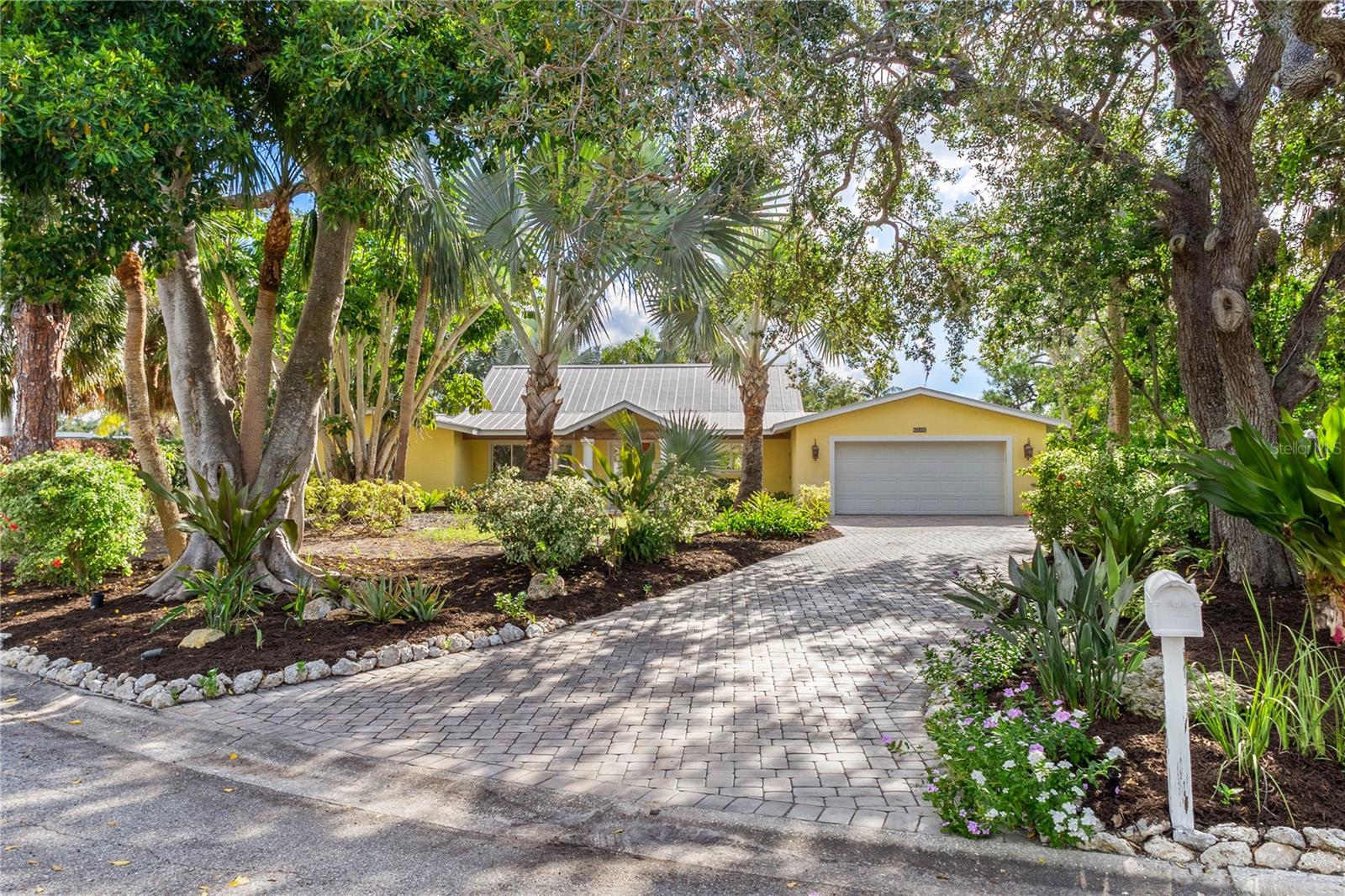 SIESTA ISLES Waterfront Gem! Nestled in the back of the neighborhood, experience the best of Siesta Key living in this beautifully maintained 3-bedroom + den, 3-bath pool home with 135+ feet of frontage on The Grand Canal. Set on an oversized 15,269 sq ft /.35-acre lot, this residence offers the perfect blend of privacy, upgrades, and waterfront lifestyle. Situated well back from the street, the home opens with a welcoming foyer and expansive great room featuring vaulted ceilings, impact windows and impact sliding glass doors flooding the space with natural light while framing serene garden and waterway views. Two bedrooms feature en-suite baths and direct access to the backyard, while the primary suite’s bath connects conveniently to the pool area. Outdoors, enjoy a private tropical retreat: swim in the sparkling pool, rinse off in the outdoor shower, or launch kayaks and paddleboards from the floating dock. With space to add a full dock or lift, boaters will love the deep water access and only one fixed bridge to the Intracoastal Waterway. Practical updates bring peace of mind, including a durable metal roof, replaced seawall cap and maintained service contracts for irrigation, AC, pest control, and alarm systems. There is a shared irrigation well that sustains the mature landscaping. The home experienced no water intrusion during last year’s storms and is truly move-in ready. A winding walkway through lush landscaping leads to the waterfront patio, while an extended brick paver driveway offers ample guest parking. Just minutes from Siesta Key’s world-famous beaches and The Village’s varied dining and shopping options, this home is ideal as a full-time residence or lucrative rental investment. Don’t miss your chance to own a slice of paradise on the Grand Canal—schedule your private showing today!