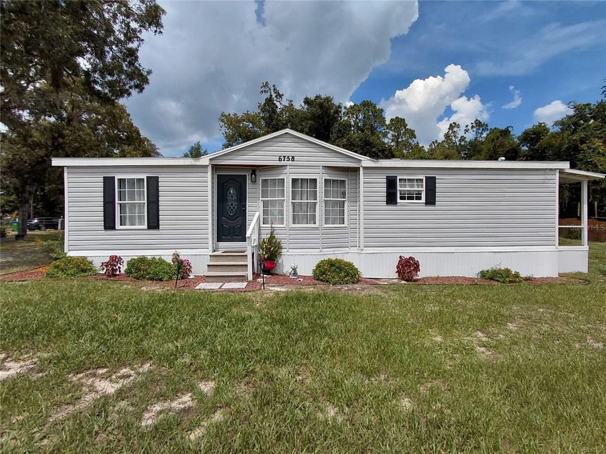 Welcome to this charming home set on a spacious, fully fenced and gated half-acre lot. With 1,180 square feet of living space, it offers 3 nice sized bedrooms with a walk-in closet in the master bedroom. 2 bathrooms, and a relaxing large open deck porch ideal for either relaxing or entertaining guests. The interior has been thoughtfully renovated, blending warmth and style with a seamless flow from room to room—creating a space that feels both open and inviting. 2 lots totaling a half-acre provides endless possibilities, whether you dream of a vibrant garden, an outdoor entertaining area, or simply room to spread out and enjoy this home is a must see! Conveniently located just minutes away from outdoor recreation and natural beauty, this move-in ready home combines comfort, space, and opportunity. All that’s missing is you! New Water softener - filtration system recently installed in late 2024 along with a new hot water heater. Electrical panel and wiring updated early 2025. New A/C installed in 2022. Storage Shed is also included.