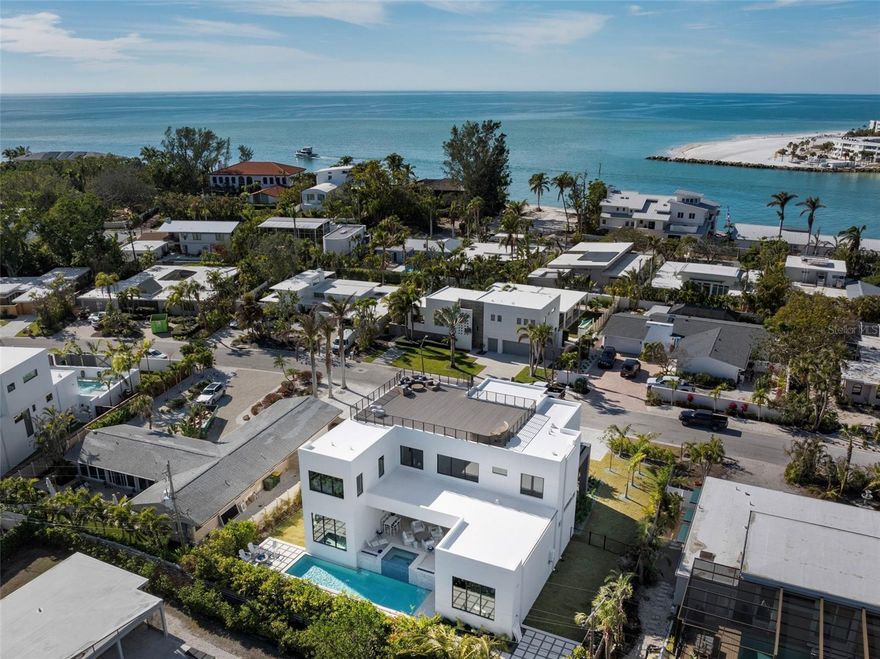 Move-in ready new construction in Lido Shores just steps from the private neighborhood beach. Skip the two-year building process and move straight into a brand new Seaward Homes residence designed for effortless coastal living.

Clean architectural lines, walls of glass, and an open yet thoughtfully scaled floor plan create a home that feels both modern and comfortable. The main living spaces flow seamlessly to the courtyard pool and outdoor entertaining areas, creating a natural connection between indoor and outdoor living.

At the center of the home, the kitchen is designed as both a showpiece and gathering space, featuring Thermador appliances, custom Italian cabinetry, and an oversized island ideal for entertaining. Generous living and dining areas allow the home to host comfortably without sacrificing privacy or everyday livability.

Each of the five bedrooms offers its own en-suite bath, creating private retreats for family and guests alike. The primary suite is designed as a true sanctuary, featuring spa-inspired finishes and a calm connection to the surrounding outdoor spaces.

One of the home’s most special features is the expansive rooftop terrace, offering sunset views toward the Gulf and a unique setting for evening entertaining or quiet moments above the neighborhood canopy.

Built by Seaward Homes and completed in 2024, the residence also includes smart home integration, custom closets, a generator, and thoughtfully curated finishes throughout.

Located in Lido Shores, one of Sarasota’s most sought-after coastal neighborhoods, residents enjoy private beach access along with convenient proximity to St. Armands Circle, downtown Sarasota, and the city’s renowned dining and cultural destinations.

Recently completed and ready for immediate occupancy, this home presents a rare opportunity to enjoy brand new construction in Lido Shores without the time, complexity, and rising costs of building.