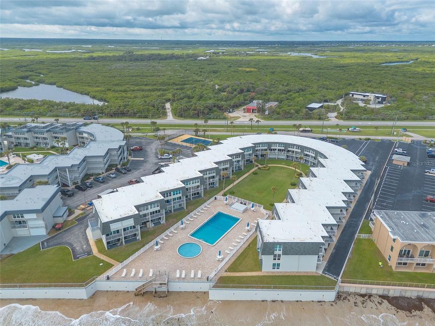 Enjoy the ultimate coastal lifestyle in this beautifully updated first-floor walk-out unit located on the peaceful south end of New Smyrna Beach, right on the no-drive section of the beach. This fully furnished 2-bedroom, 2-bath condo offers convenience, comfort, and income potential with short-term rentals allowed. Step inside to find a bright living area featuring luxury vinyl tile flooring throughout and tasteful coastal décor. The updated bathrooms add a touch of modern style, and a stackable washer and dryer make daily living easy. Relax or entertain on your private patio just steps from the oceanfront pool and hot tub, or stroll directly from your door to the beach for sunrise walks. With parking right outside your front door, this unit offers both ease and accessibility. Perfect as a vacation home, rental property, or full-time residence—experience the best of New Smyrna Beach living in this exceptional oceanfront condo.